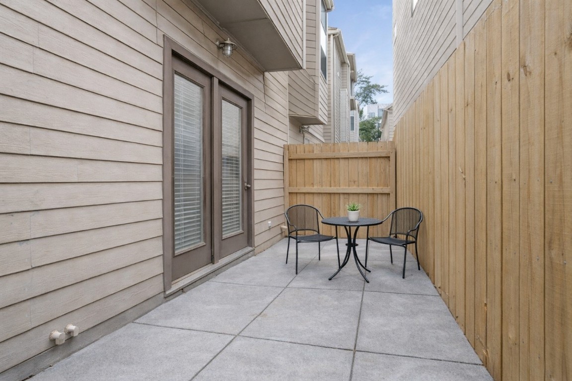 121 Roy Street Houston, TX 77007 - Photo 32 of 33 a view of a patio with table and chairs with wooden floor and plants
