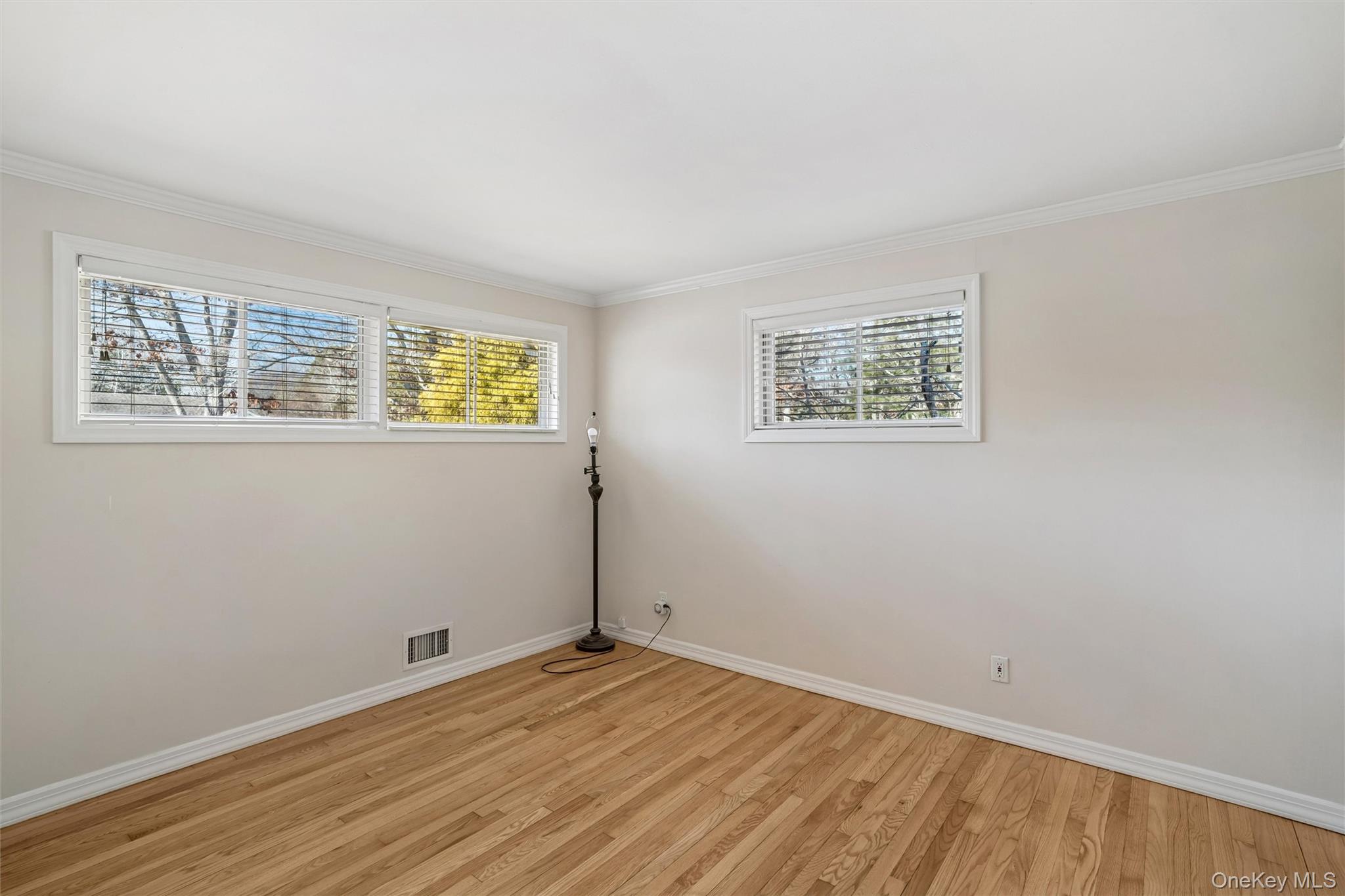 58 Old Depot Road Quogue, NY 11959 - Photo 11 of 28 wooden floor in an empty room with a window