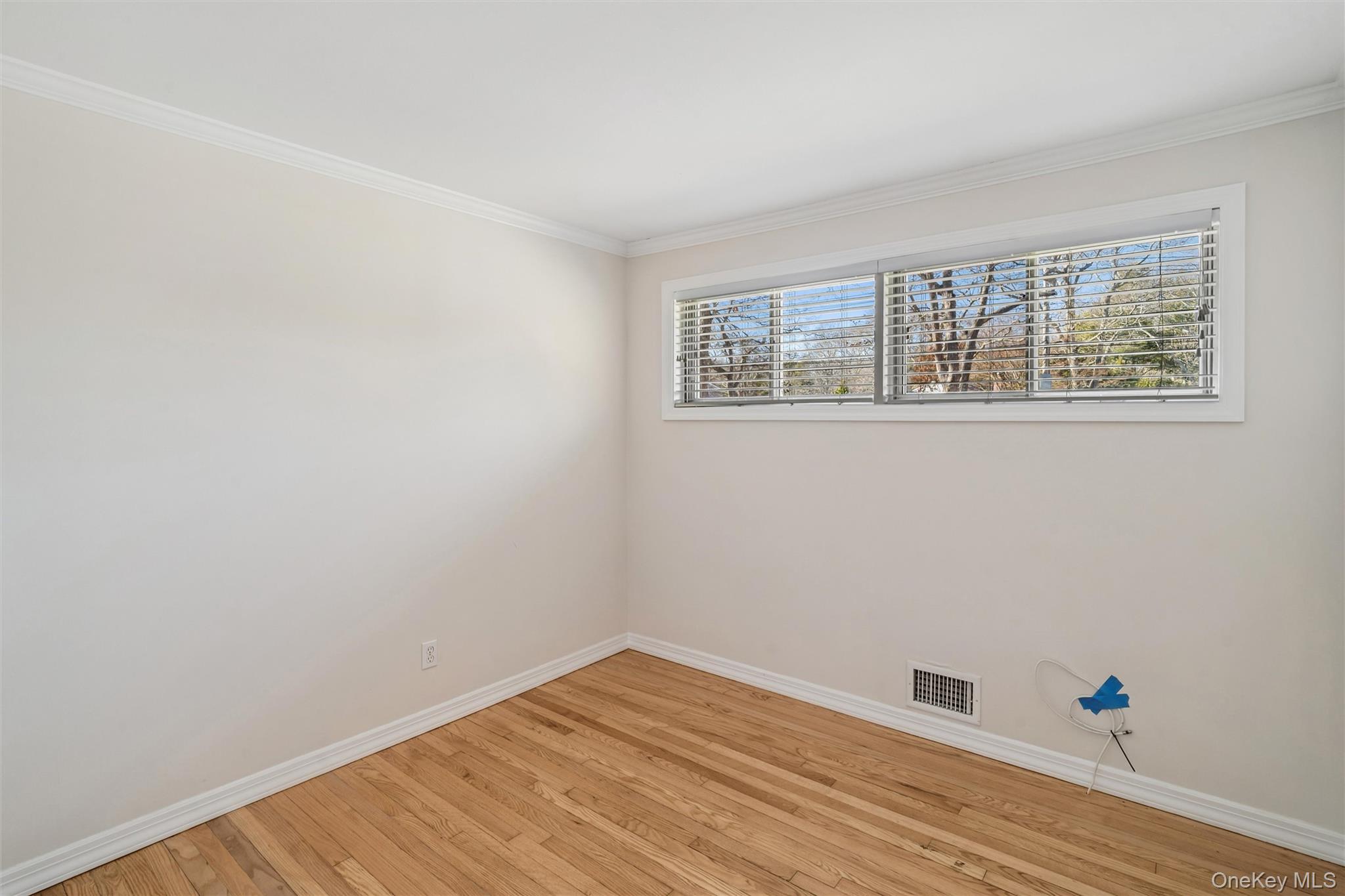 58 Old Depot Road Quogue, NY 11959 - Photo 12 of 28 a view of an empty room with wooden floor and a window