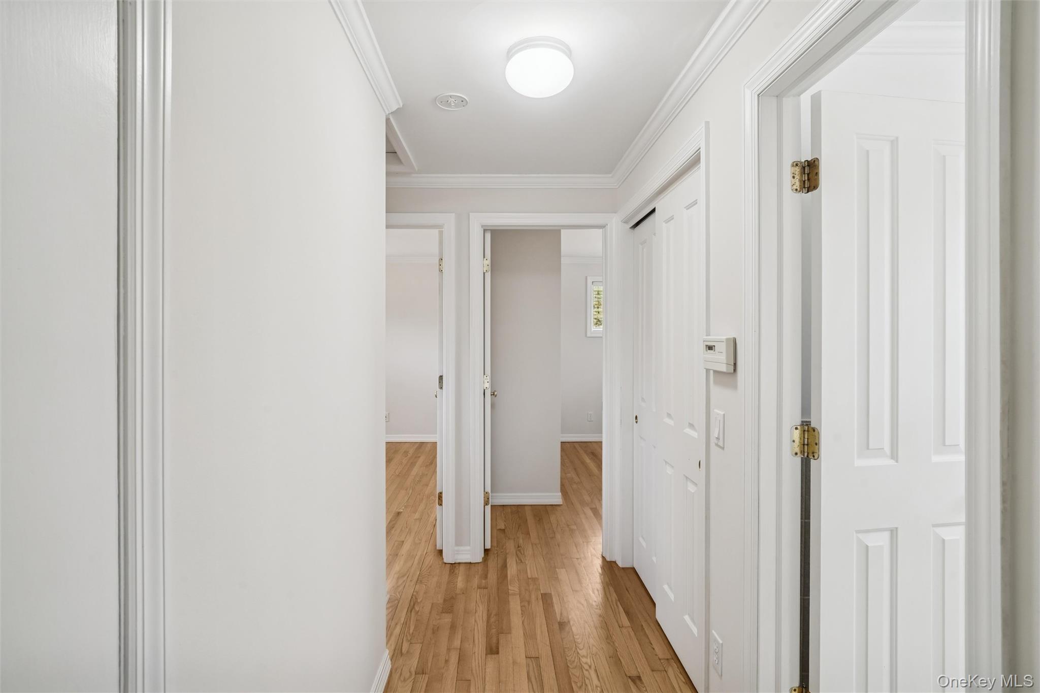 58 Old Depot Road Quogue, NY 11959 - Photo 15 of 28 a view of a hallway with wooden floor
