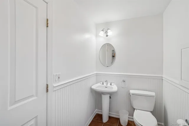 a bathroom with a sink mirror and toilet