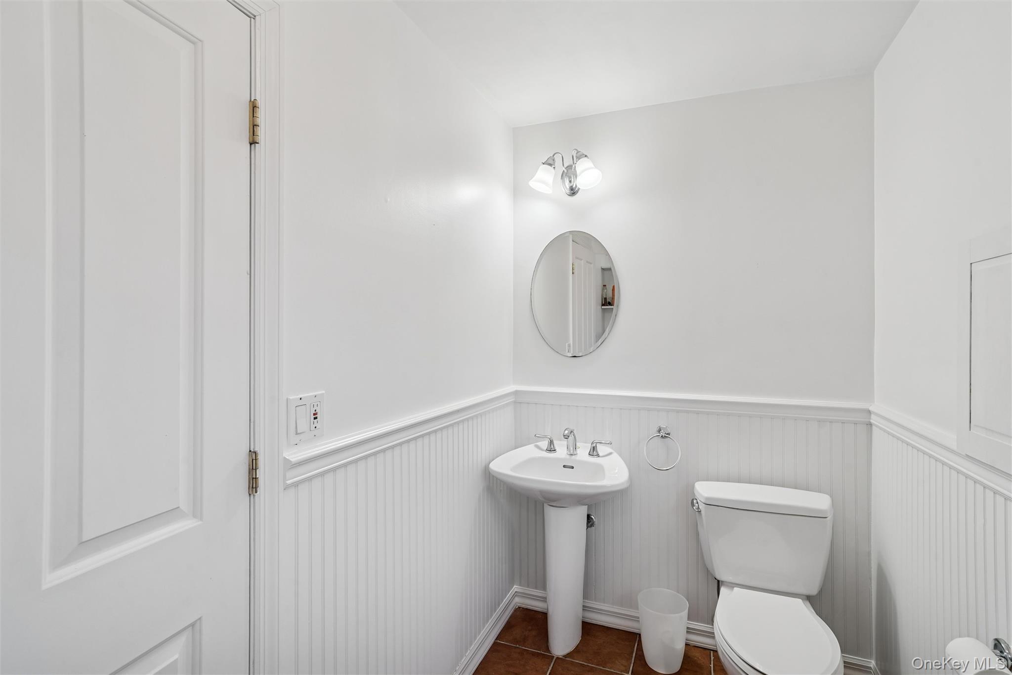 58 Old Depot Road Quogue, NY 11959 - Photo 17 of 28 a bathroom with a sink mirror and toilet