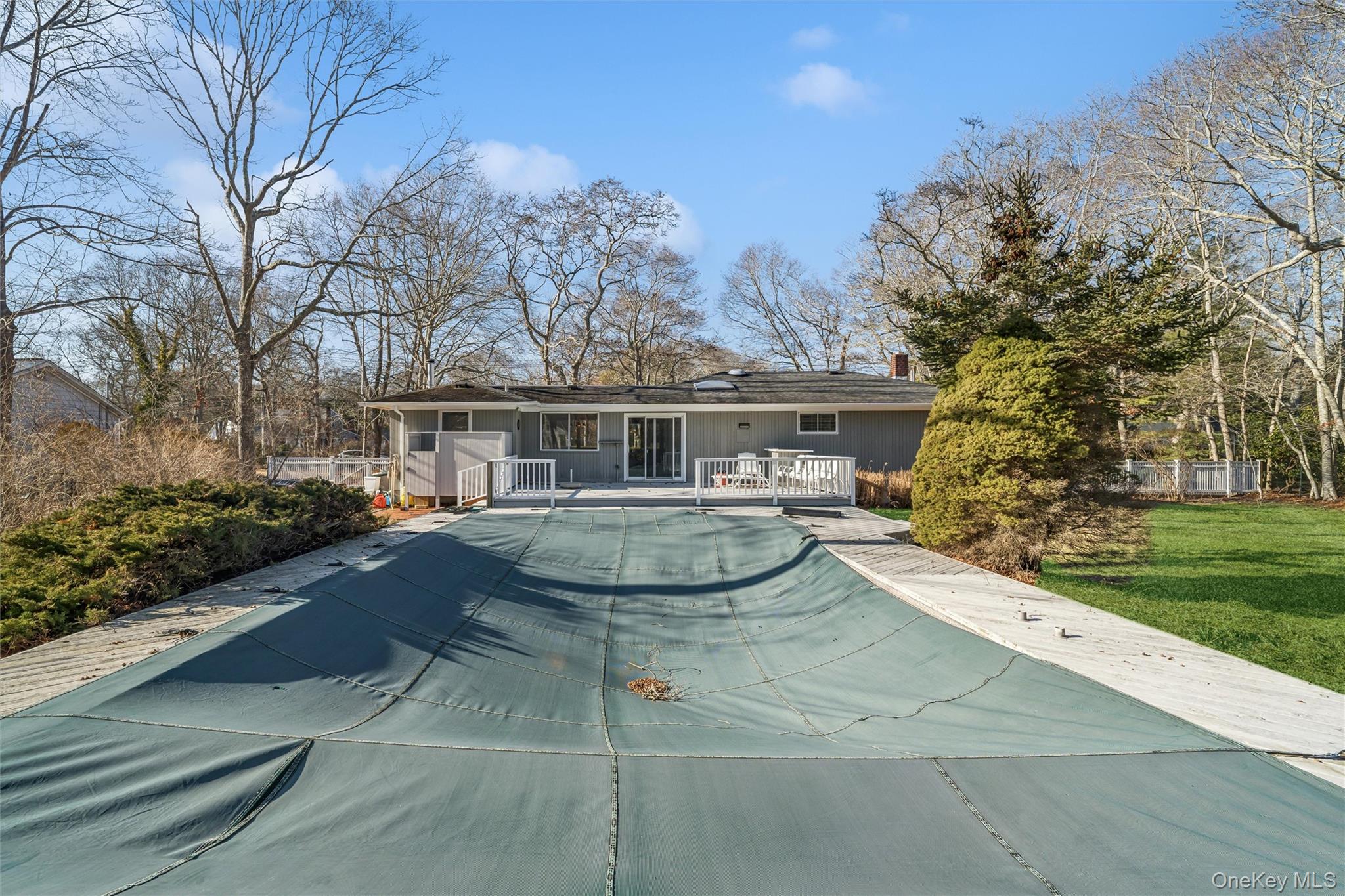 58 Old Depot Road Quogue, NY 11959 - Photo 23 of 28 a view of a white house with a yard