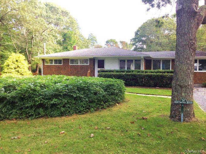 58 Old Depot Road Quogue, NY 11959 - Photo 25 of 28 a front view of a house with garden