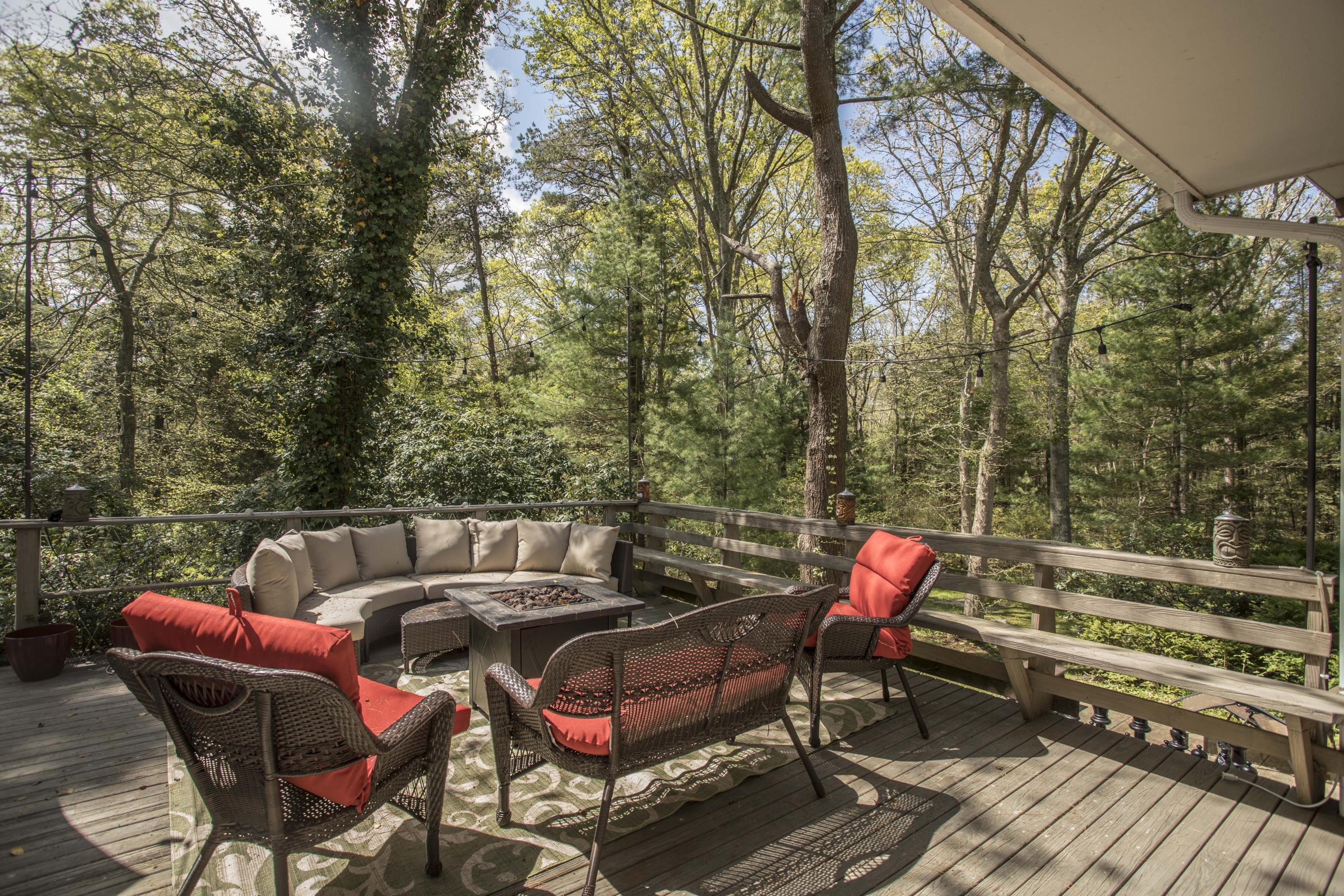 14 Ridge Road North Falmouth, MA 02556 - Photo 21 of 22 a patio with water view fountain and wooden bench