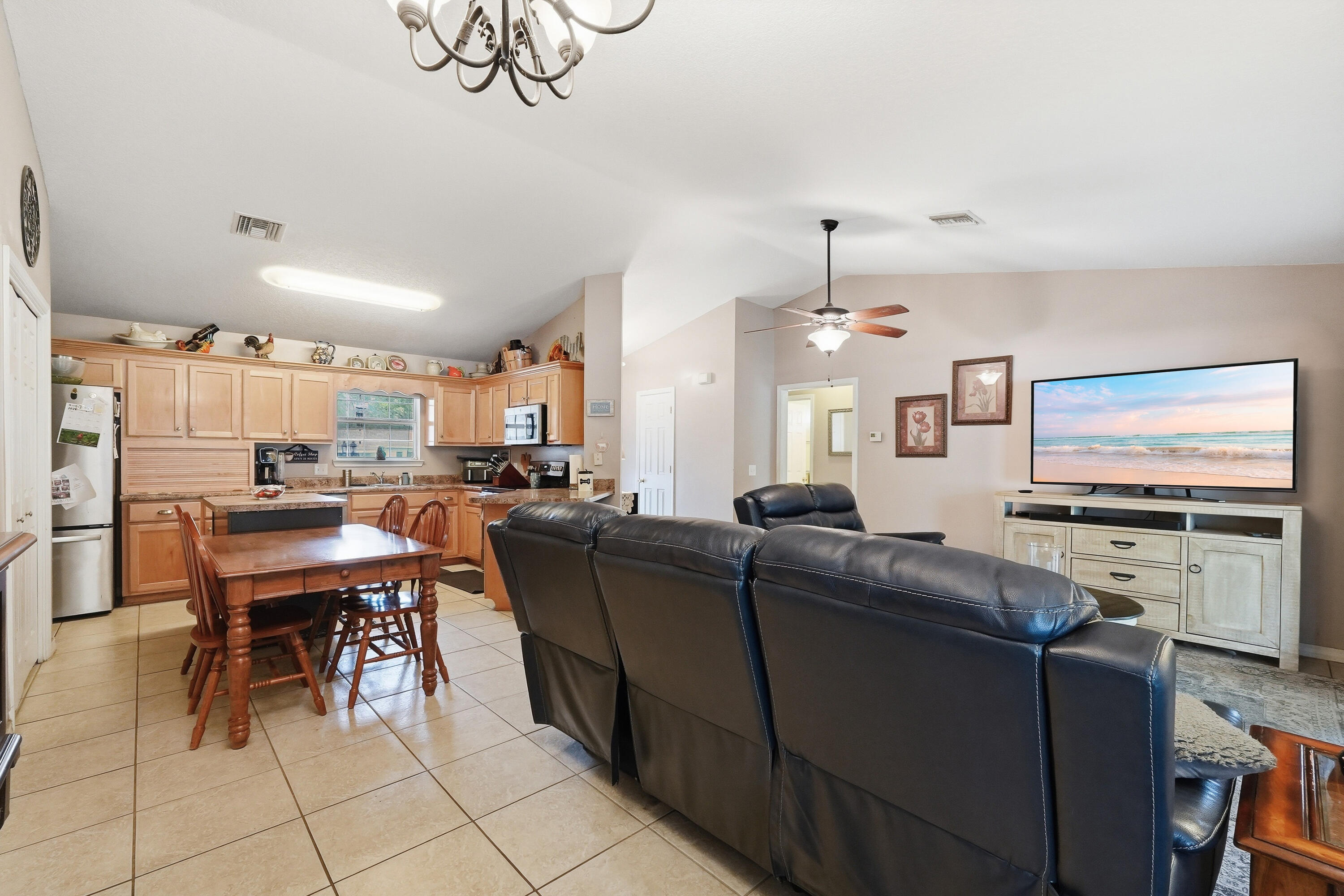 4237 Melton Road Milton, FL 32583 - Photo 43 of 43 a living room with furniture a flat screen tv and kitchen view