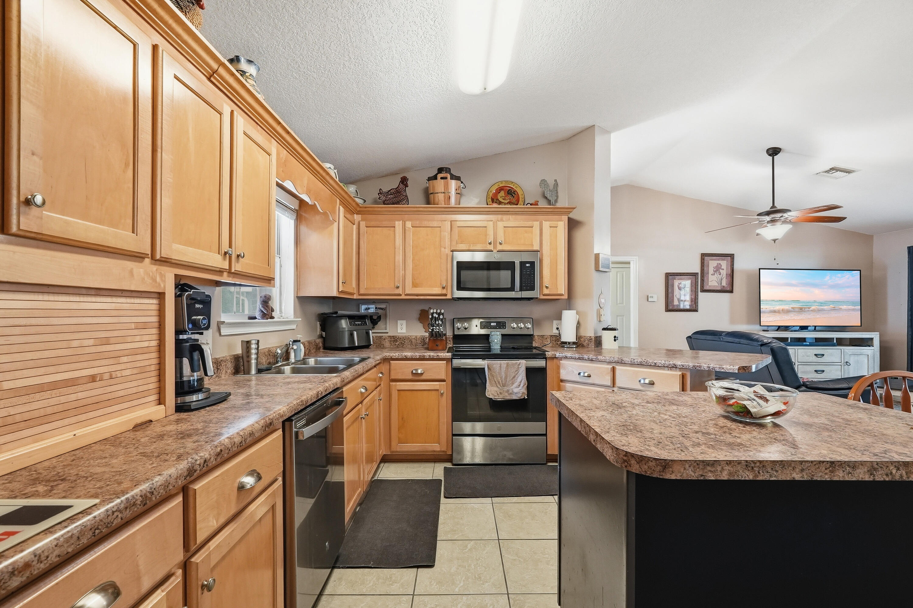 4237 Melton Road Milton, FL 32583 - Photo 11 of 43 a kitchen with granite countertop a sink and a stove