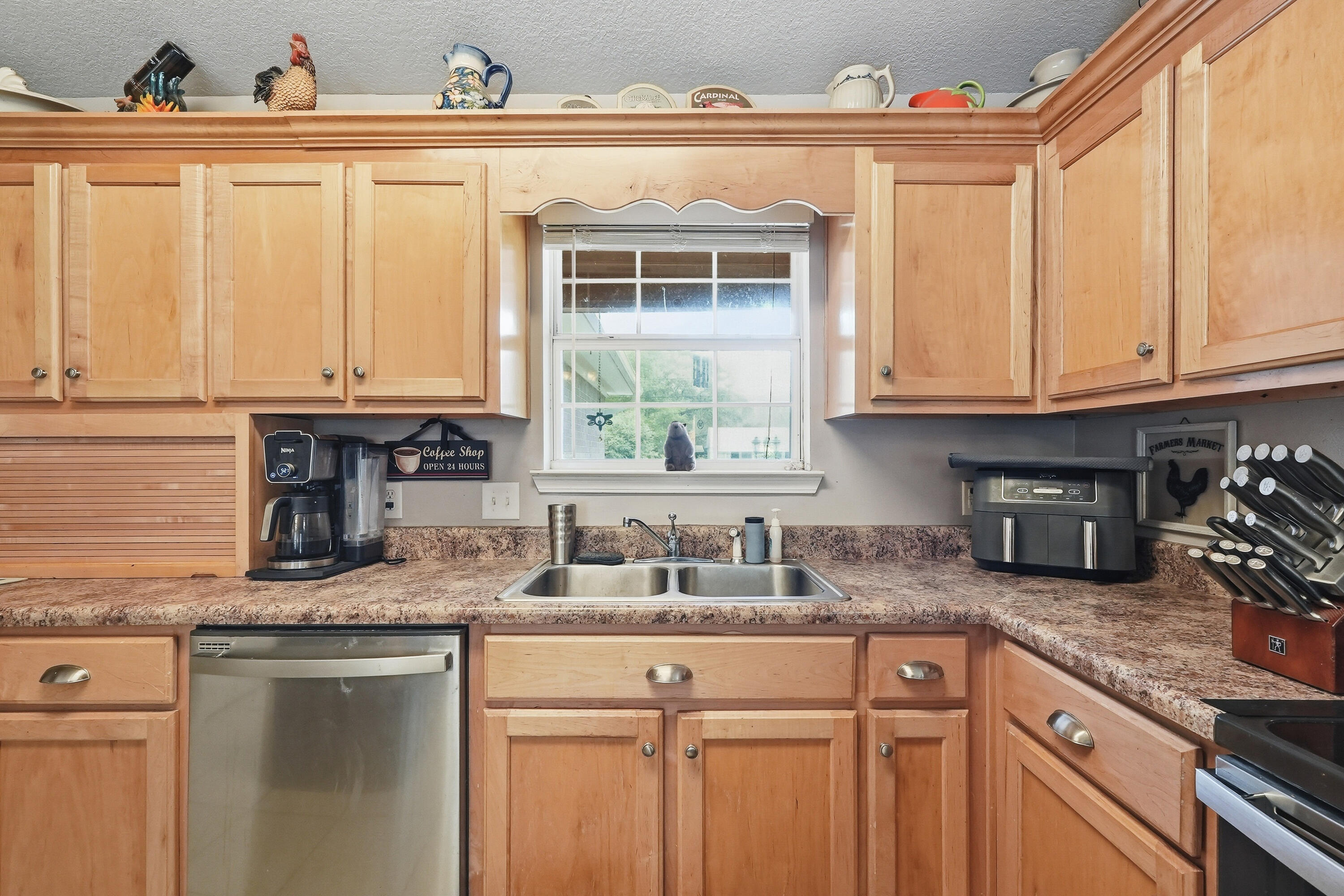 4237 Melton Road Milton, FL 32583 - Photo 14 of 43 a kitchen with granite countertop a sink stove and cabinets