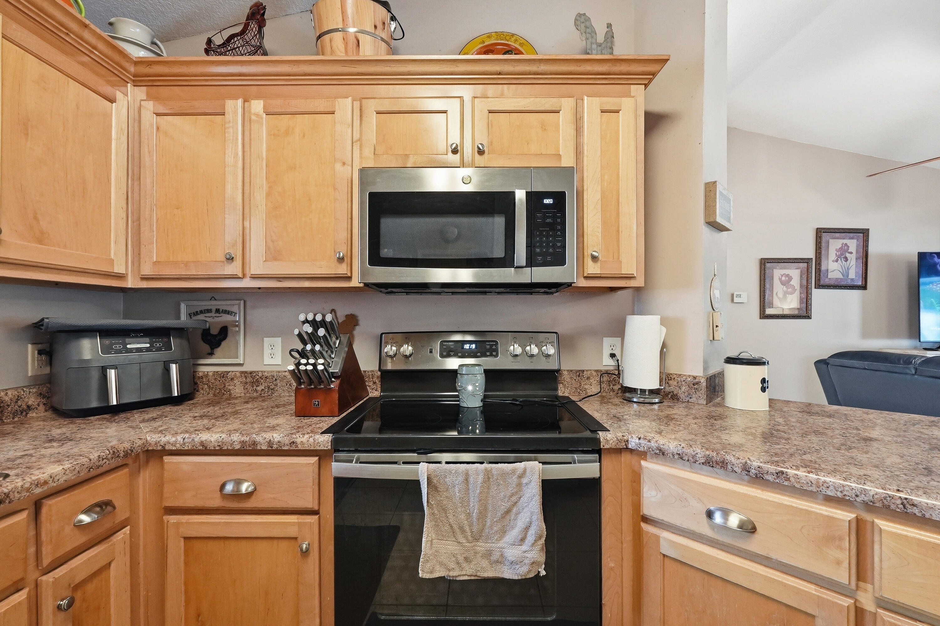 4237 Melton Road Milton, FL 32583 - Photo 16 of 43 a kitchen with granite countertop a stove sink and microwave