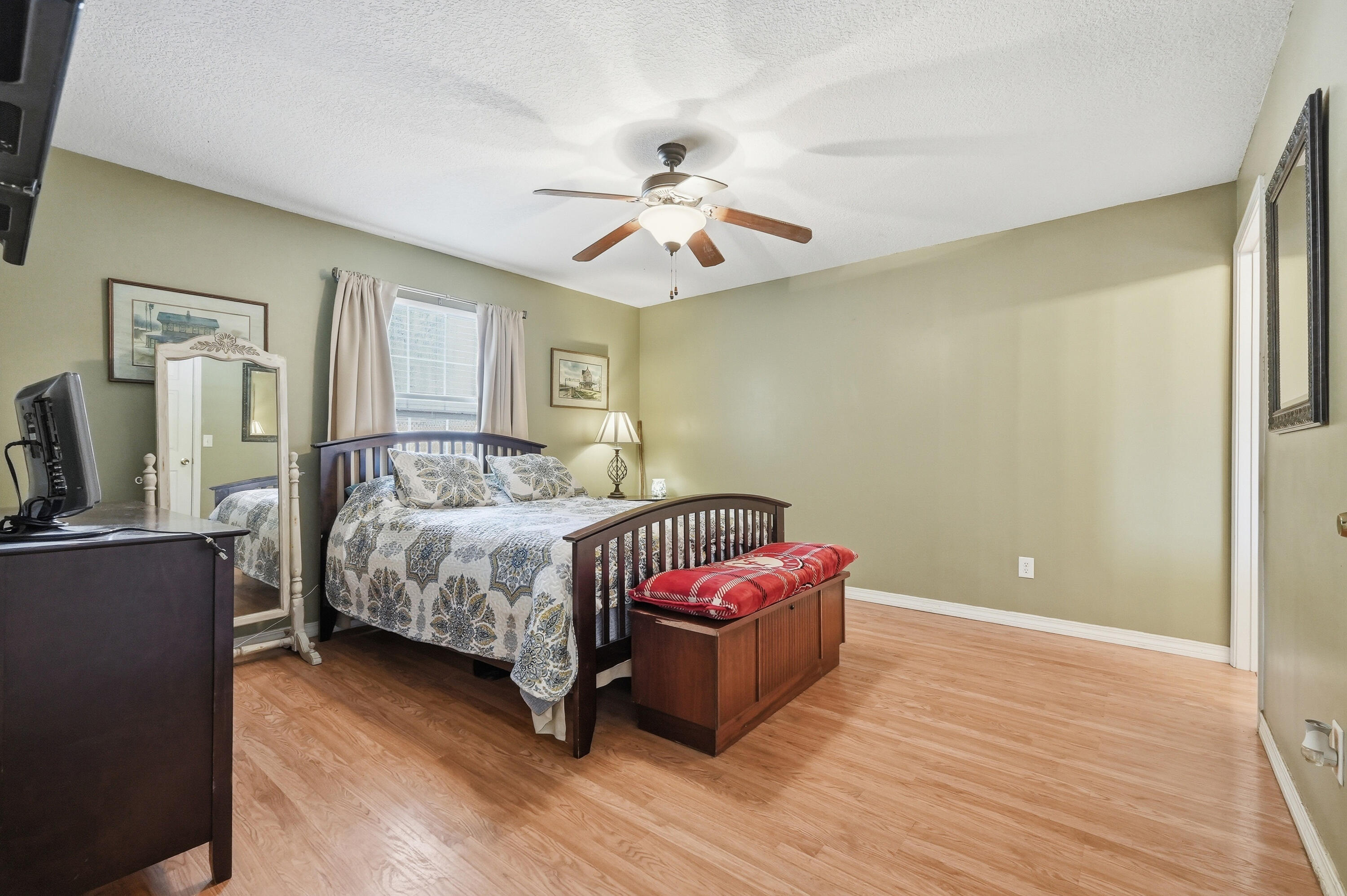 4237 Melton Road Milton, FL 32583 - Photo 18 of 43 a bedroom with a bed and wooden floor