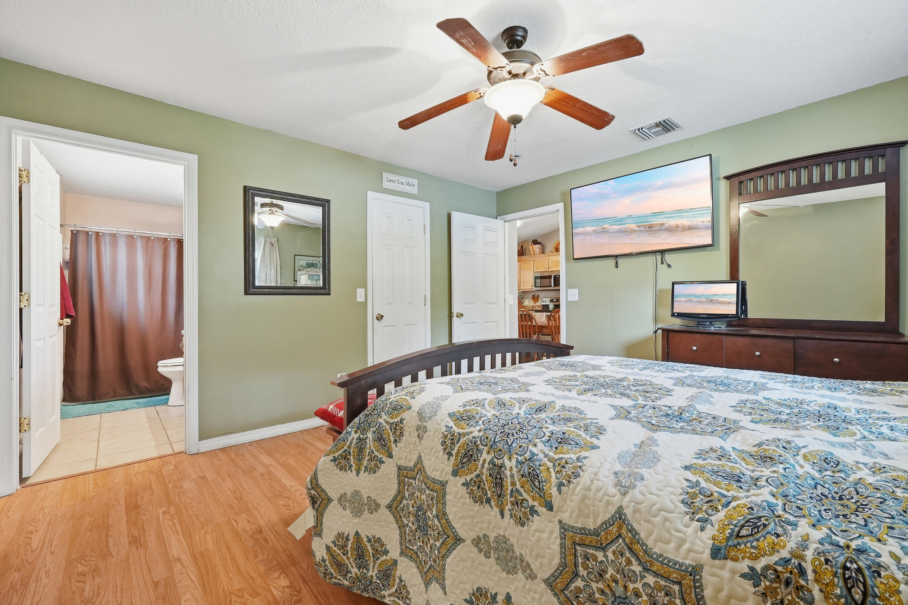 4237 Melton Road Milton, FL 32583 - Photo 20 of 43 a bedroom with a bed and a chandelier
