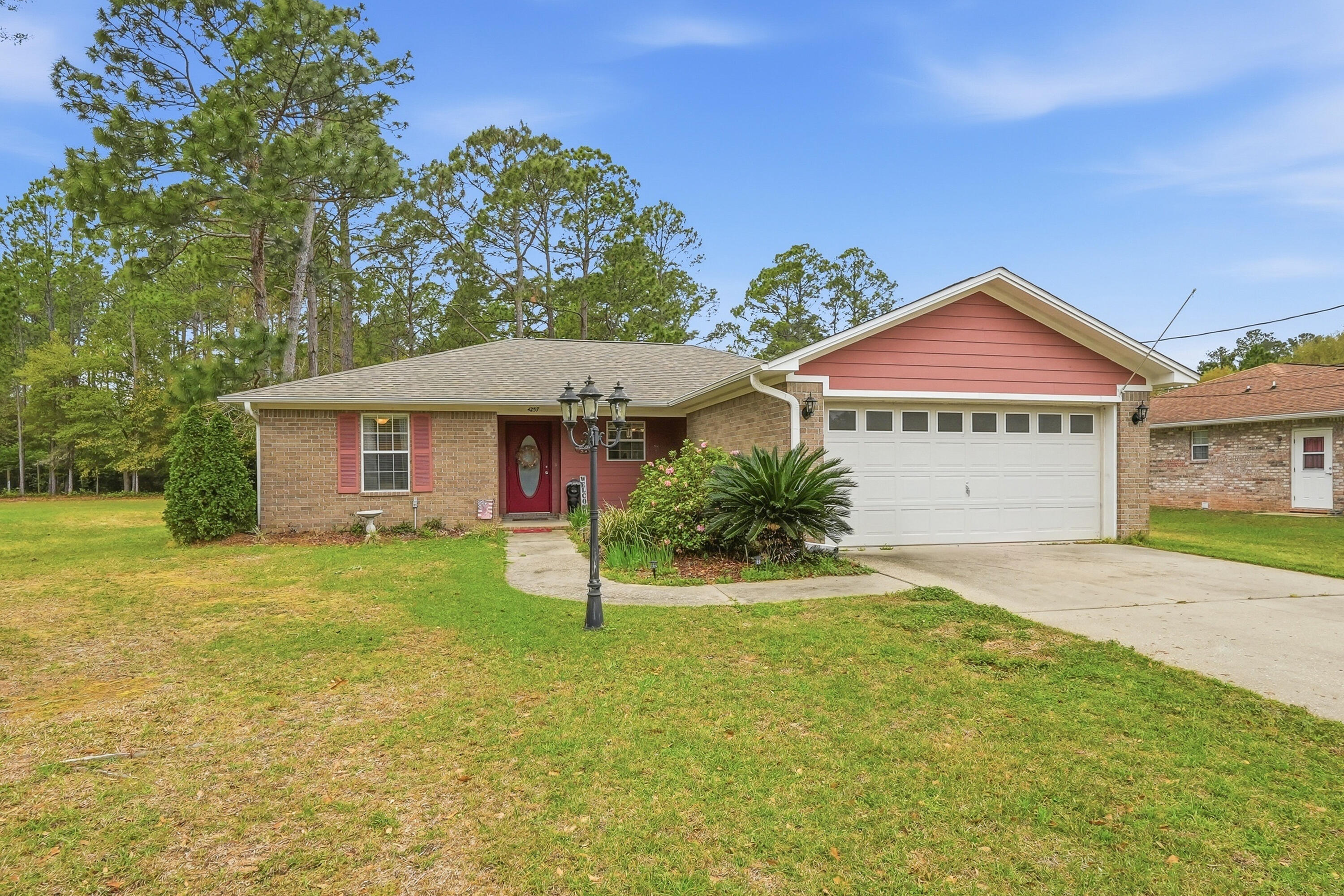 4237 Melton Road Milton, FL 32583 - Photo 3 of 43 a view of a house with a yard and tree
