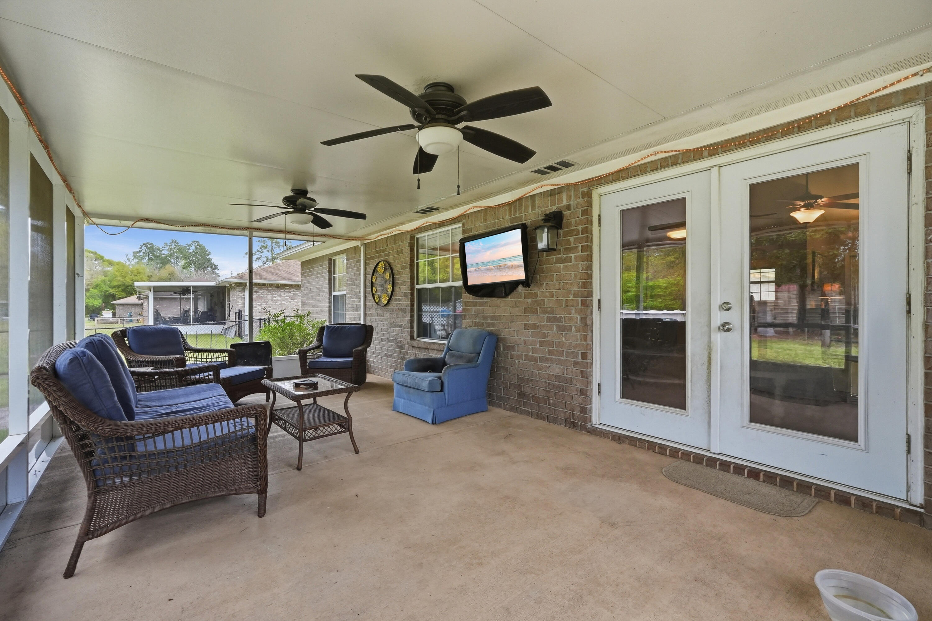 4237 Melton Road Milton, FL 32583 - Photo 32 of 43 a living room with furniture a ceiling fan and a window