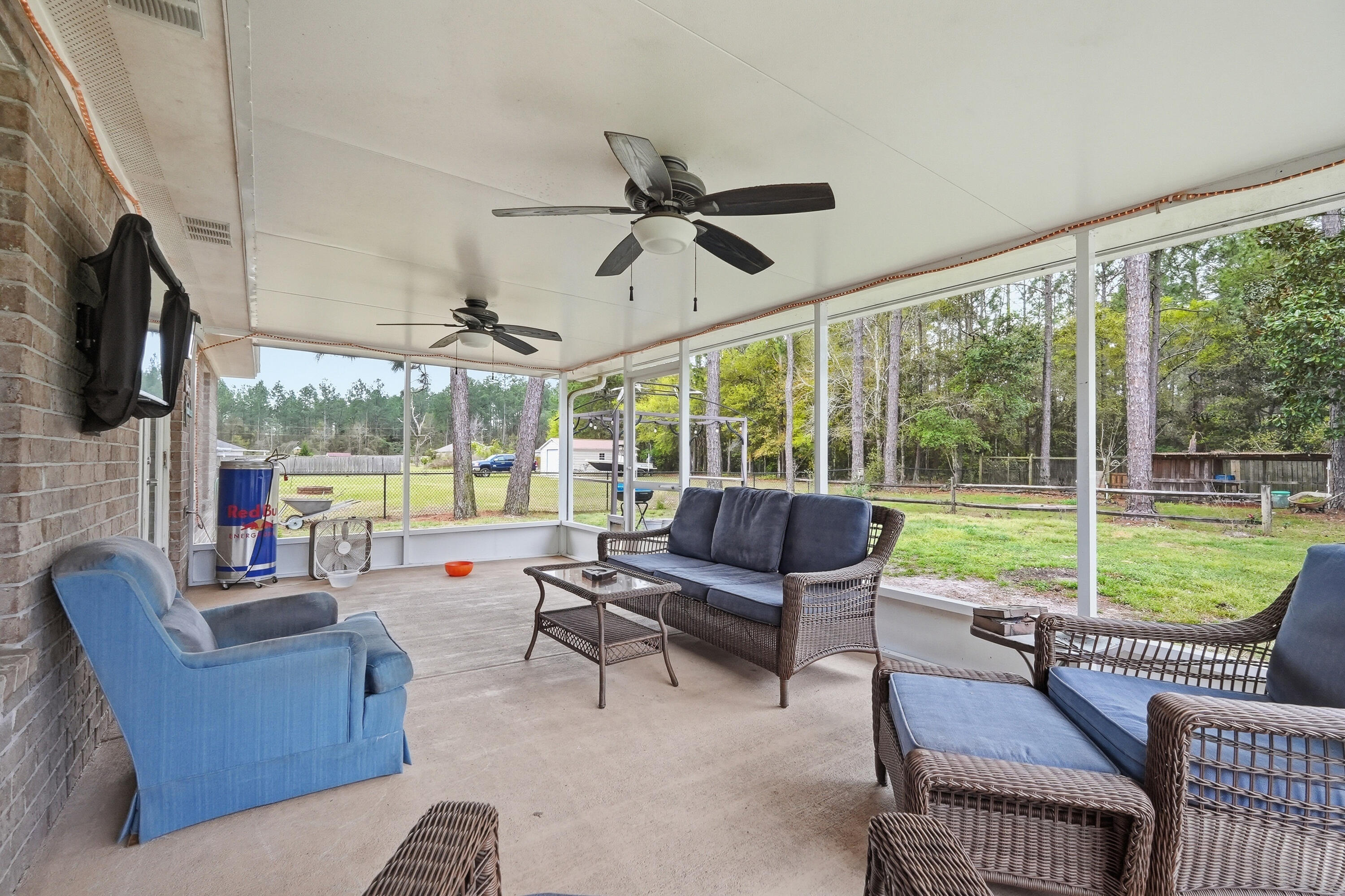 4237 Melton Road Milton, FL 32583 - Photo 33 of 43 a living room with patio furniture and a floor to ceiling window