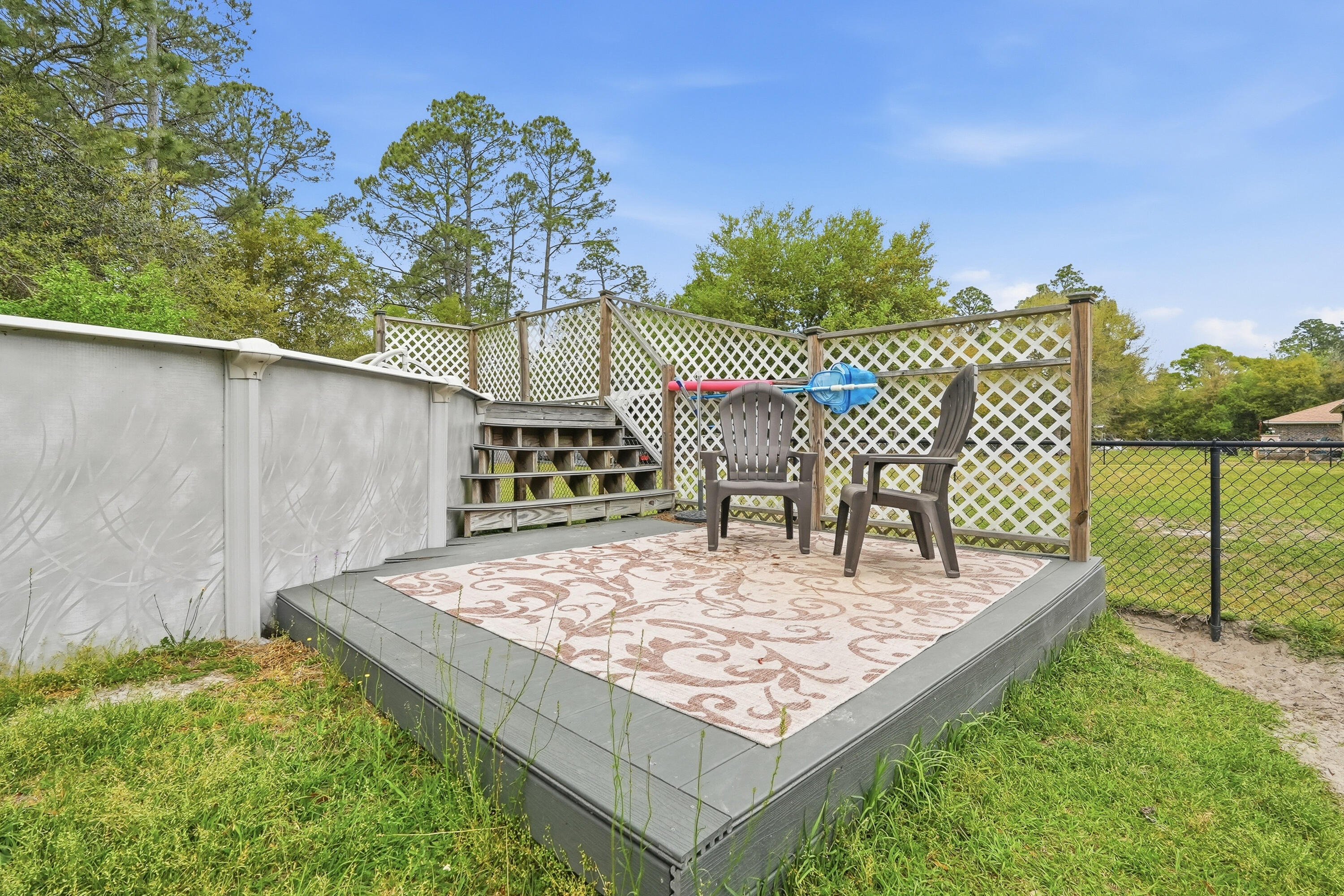 4237 Melton Road Milton, FL 32583 - Photo 34 of 43 a view of a backyard with a patio and outdoor seating