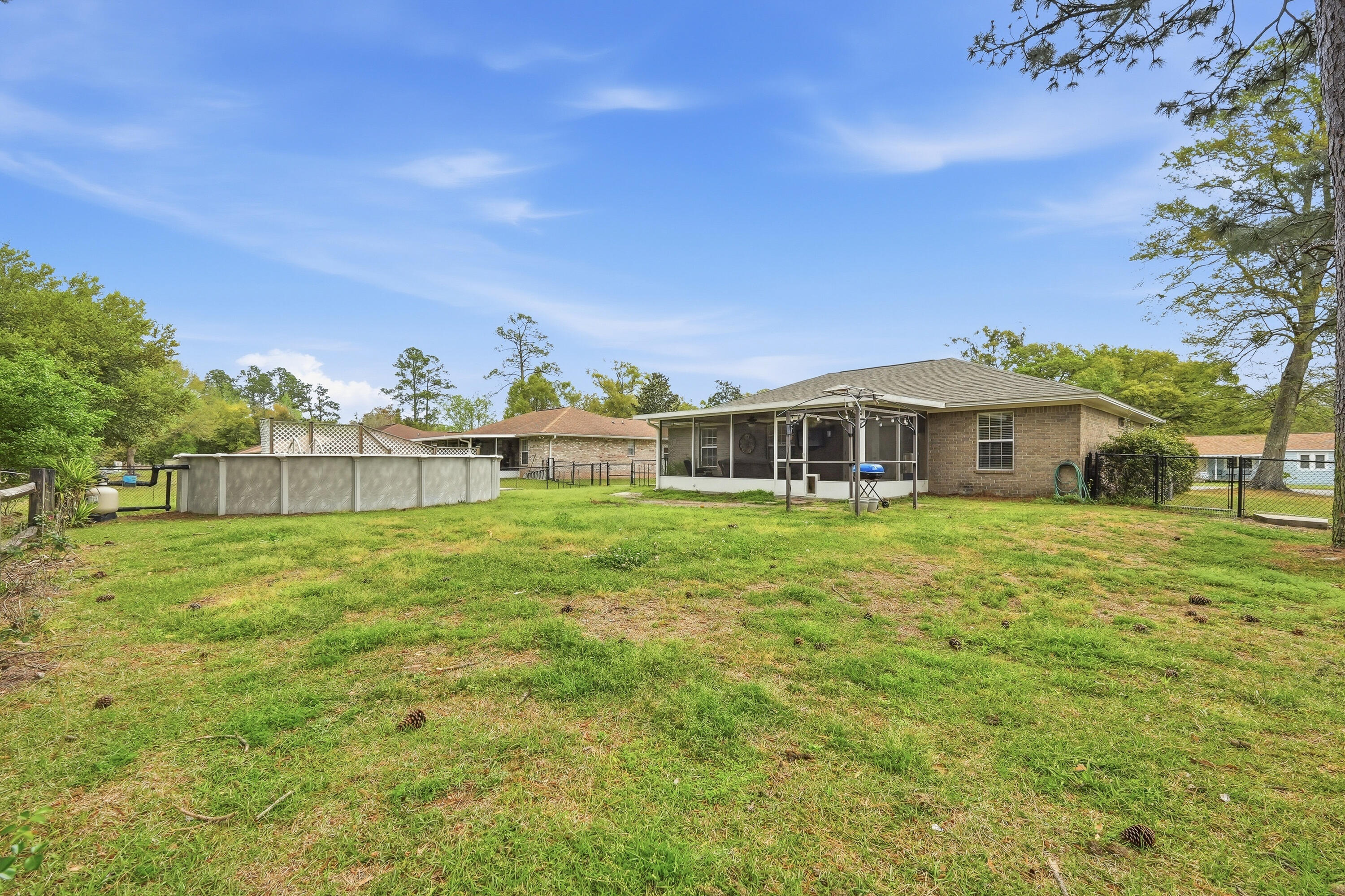 4237 Melton Road Milton, FL 32583 - Photo 38 of 43 a front view of house with yard and trees in the background