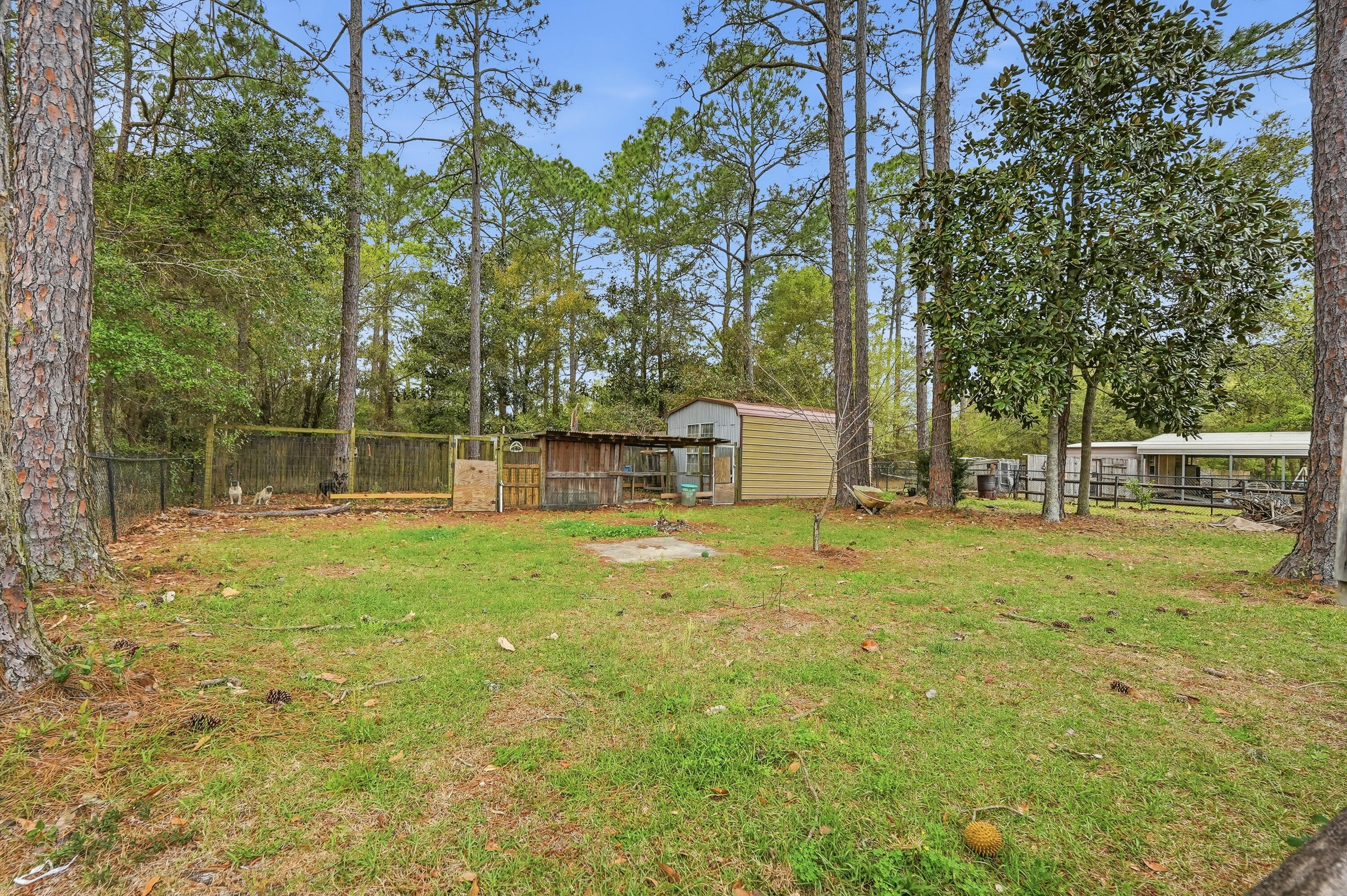 4237 Melton Road Milton, FL 32583 - Photo 39 of 43 a backyard of a house with lots of green space and fountain