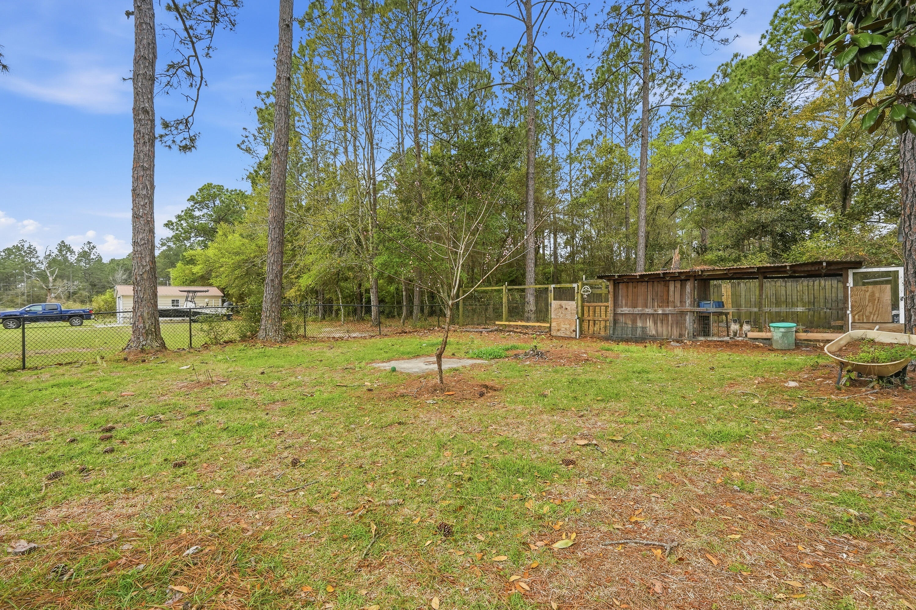 4237 Melton Road Milton, FL 32583 - Photo 40 of 43 a swimming pool with lots of tress in the background