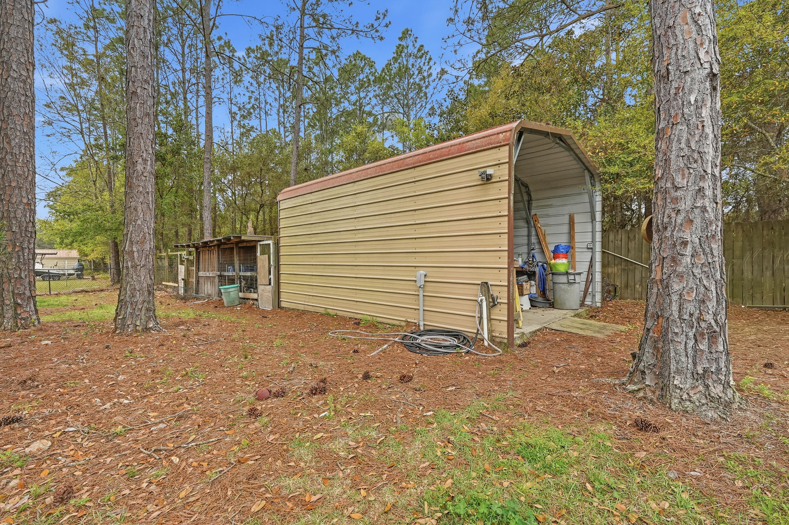 4237 Melton Road Milton, FL 32583 - Photo 41 of 43 a view of a house with a tree and garage