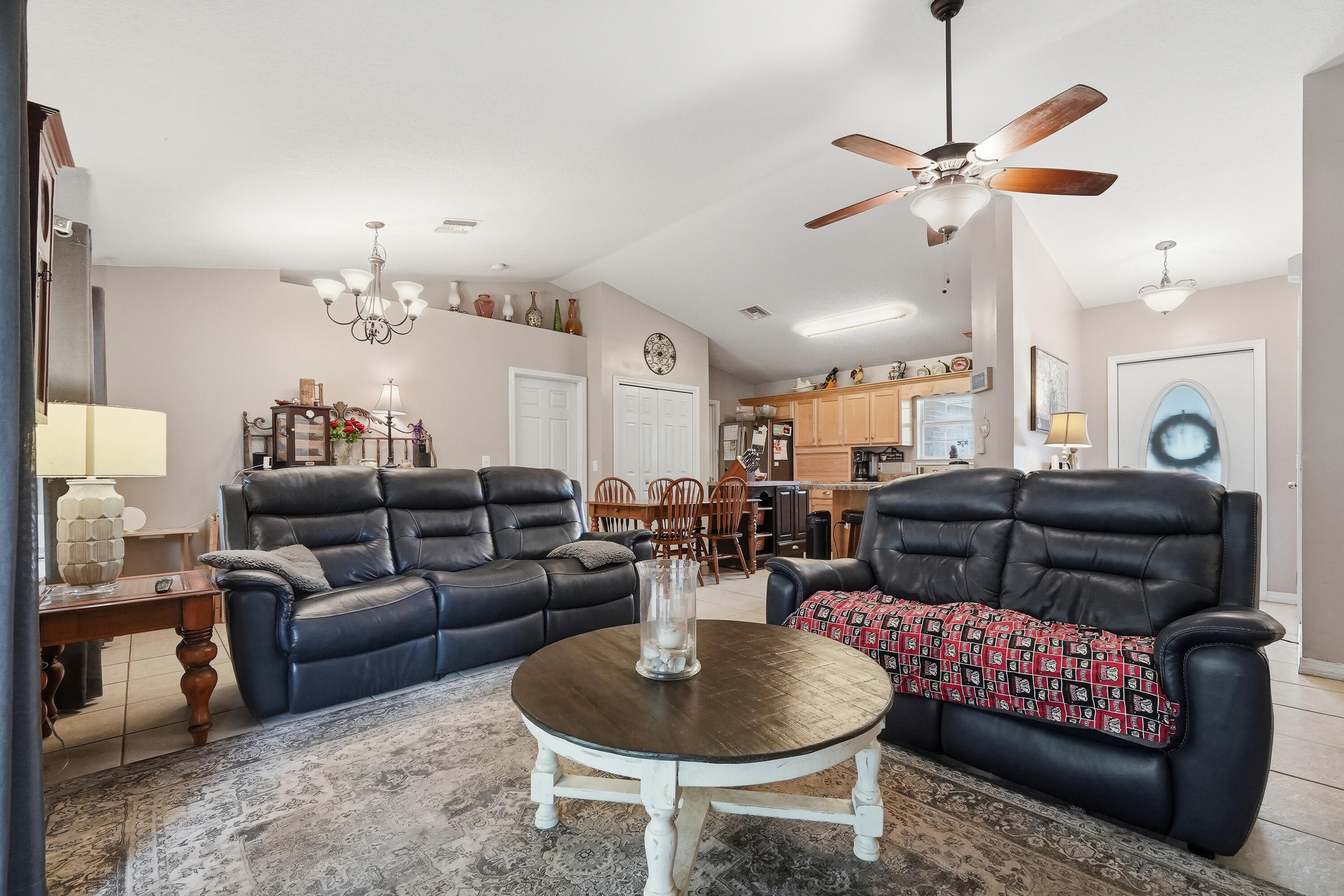 4237 Melton Road Milton, FL 32583 - Photo 7 of 43 a living room with furniture and a chandelier