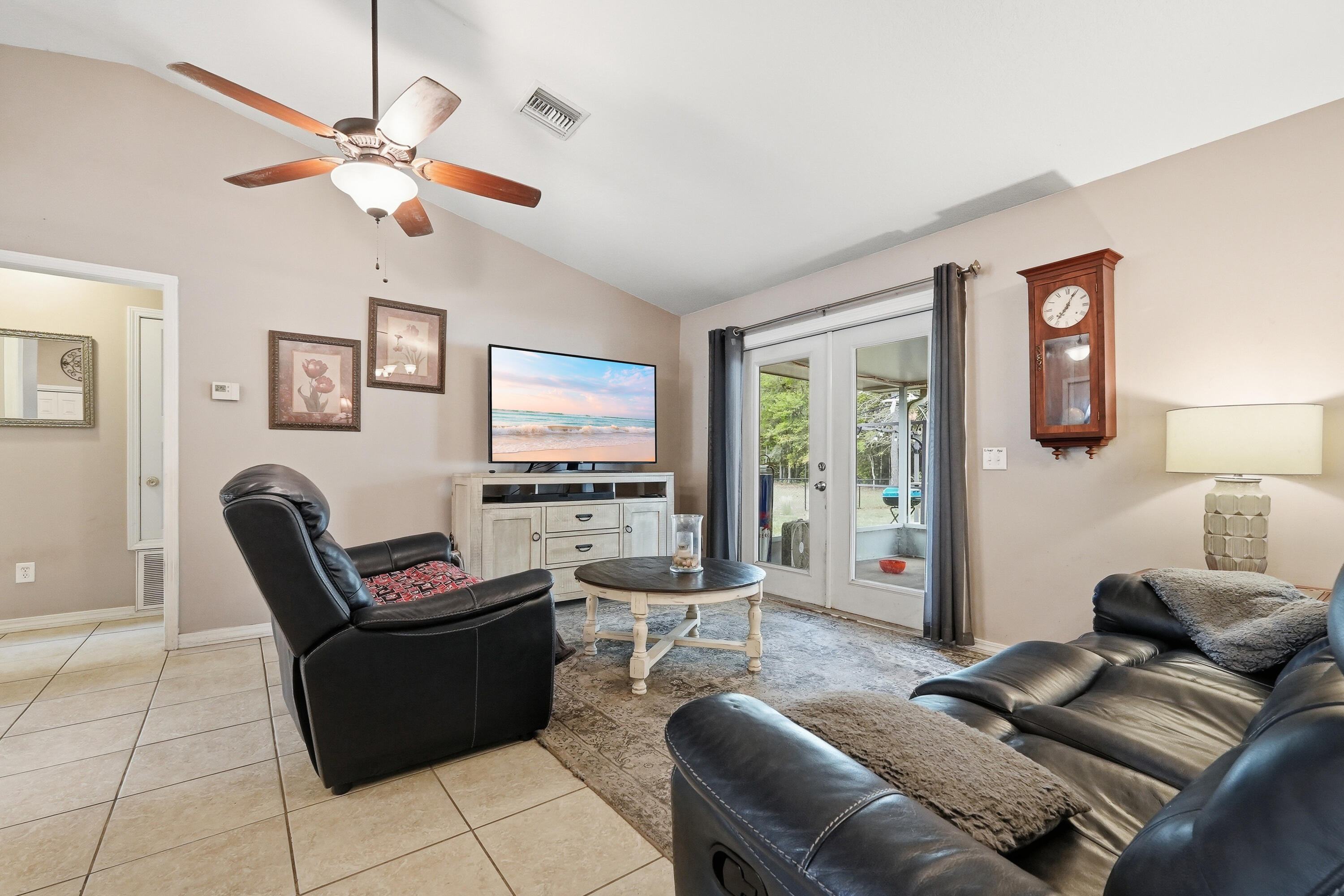 4237 Melton Road Milton, FL 32583 - Photo 10 of 43 a living room with furniture a ceiling fan and a window