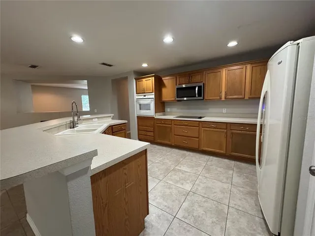 a kitchen with a sink a stove a refrigerator and a sink