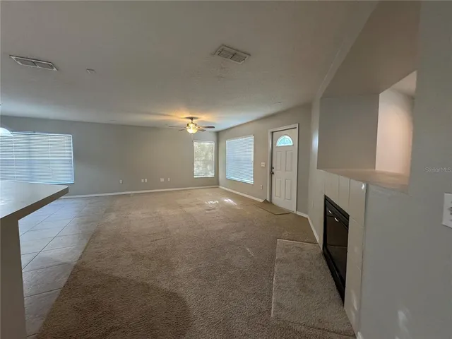 a view of a livingroom with an empty space and a fireplace
