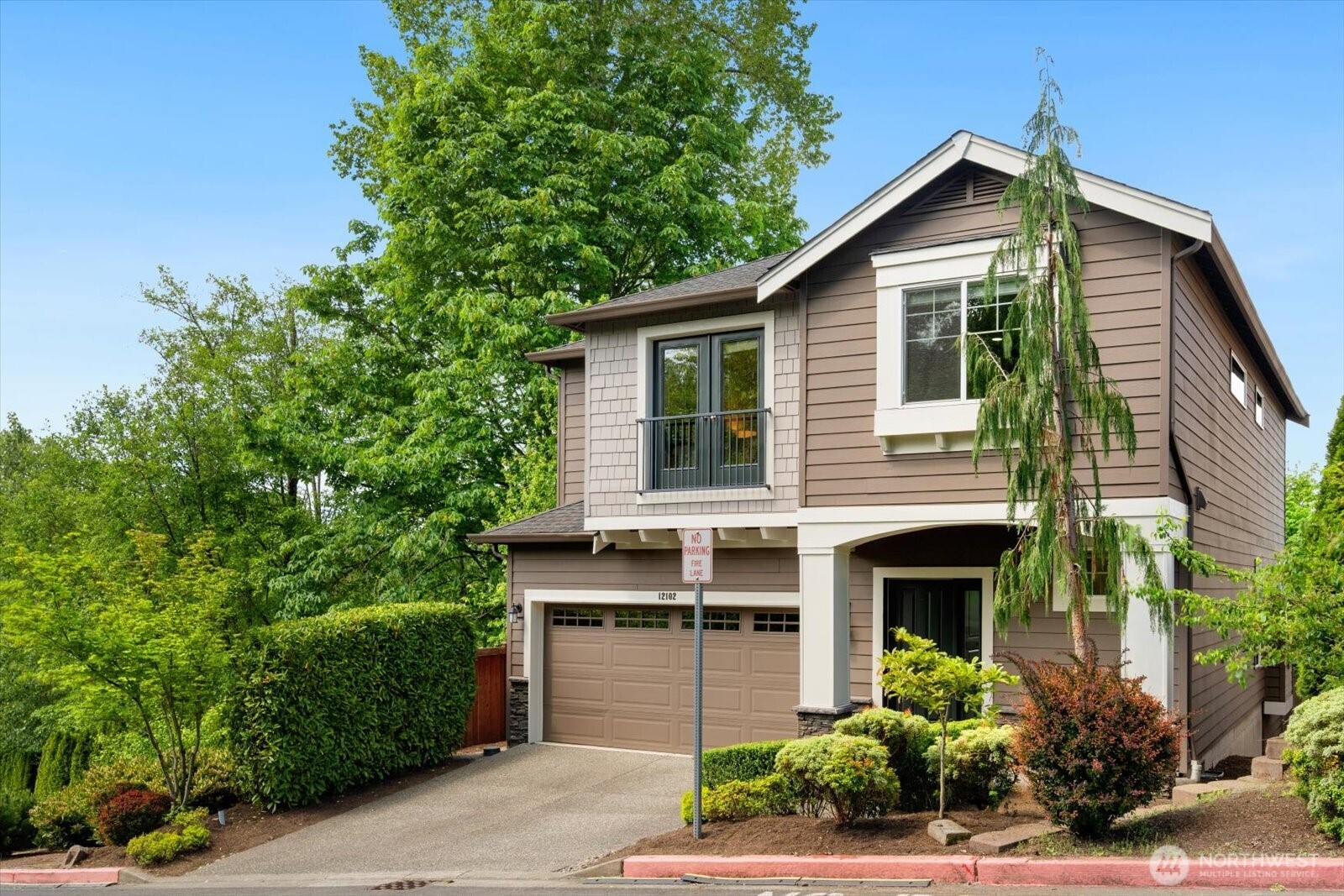 a front view of a house with a garden