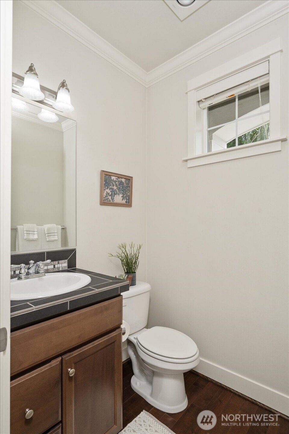 12102 Northeast 174th Street, Unit 1 Bothell, WA 98011 - Photo 16 of 40 a bathroom with a sink a toilet and mirror