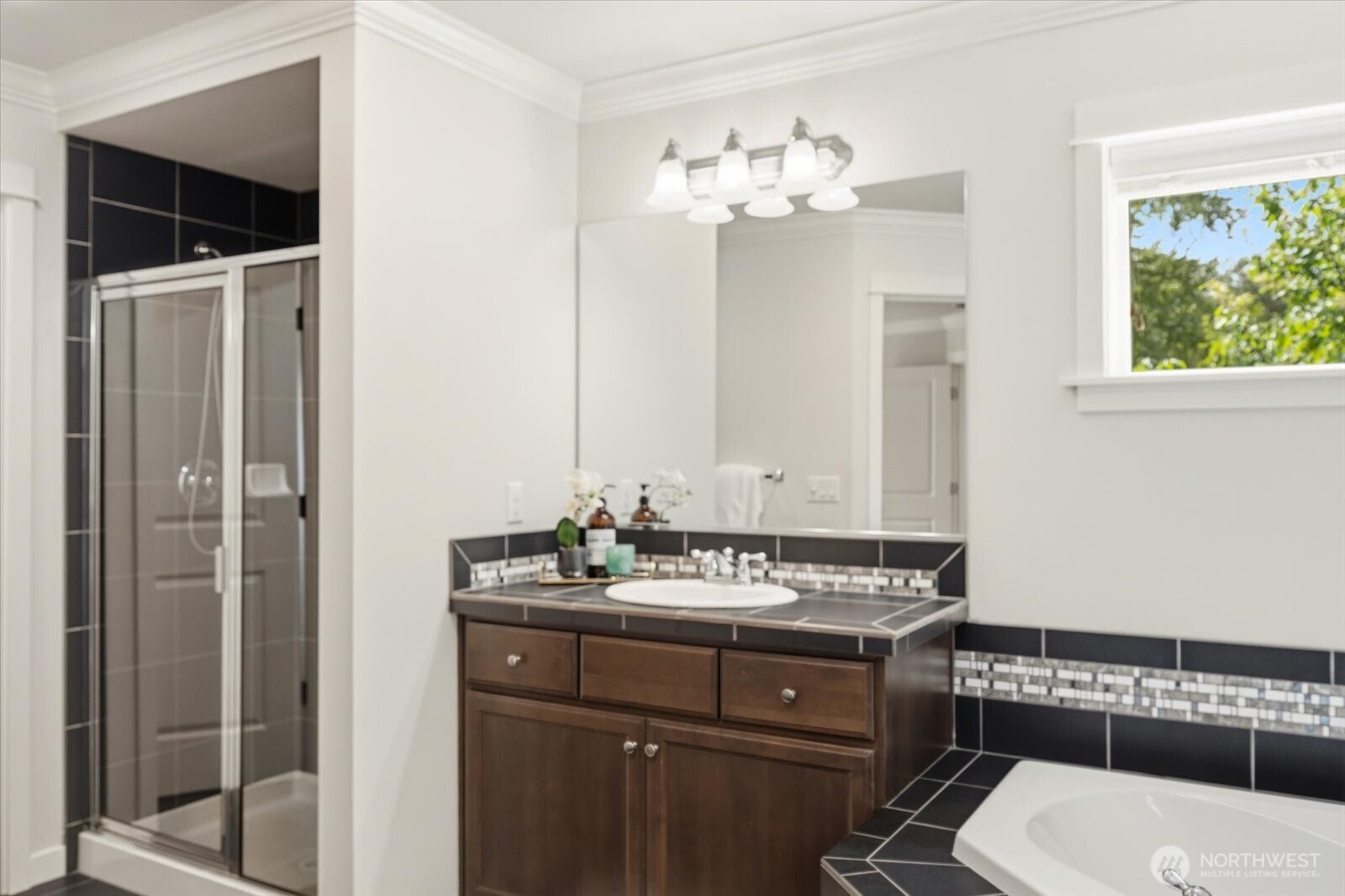 12102 Northeast 174th Street, Unit 1 Bothell, WA 98011 - Photo 21 of 40 a bathroom with a sink a toilet and shower