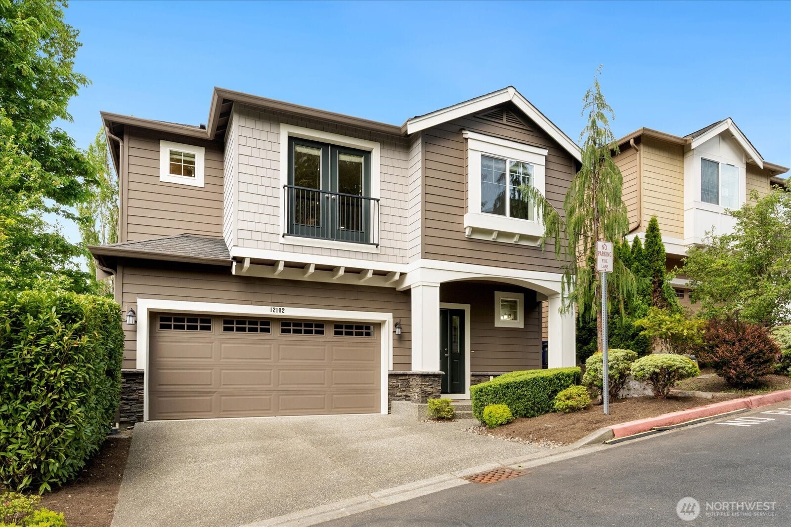 12102 Northeast 174th Street, Unit 1 Bothell, WA 98011 - Photo 36 of 40 a front view of a house with a garden and garage