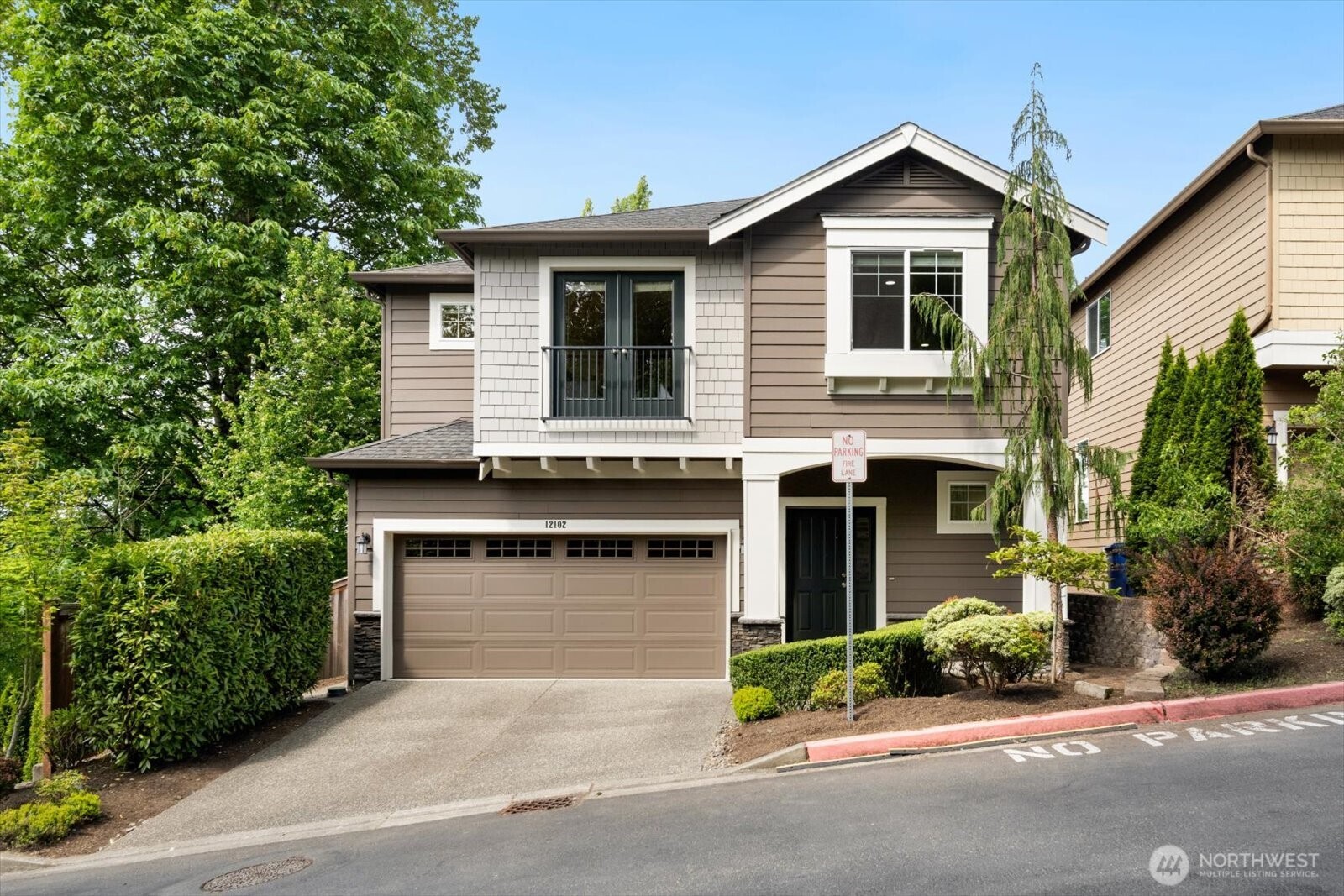 12102 Northeast 174th Street, Unit 1 Bothell, WA 98011 - Photo 40 of 40 a front view of a house with garage and plants
