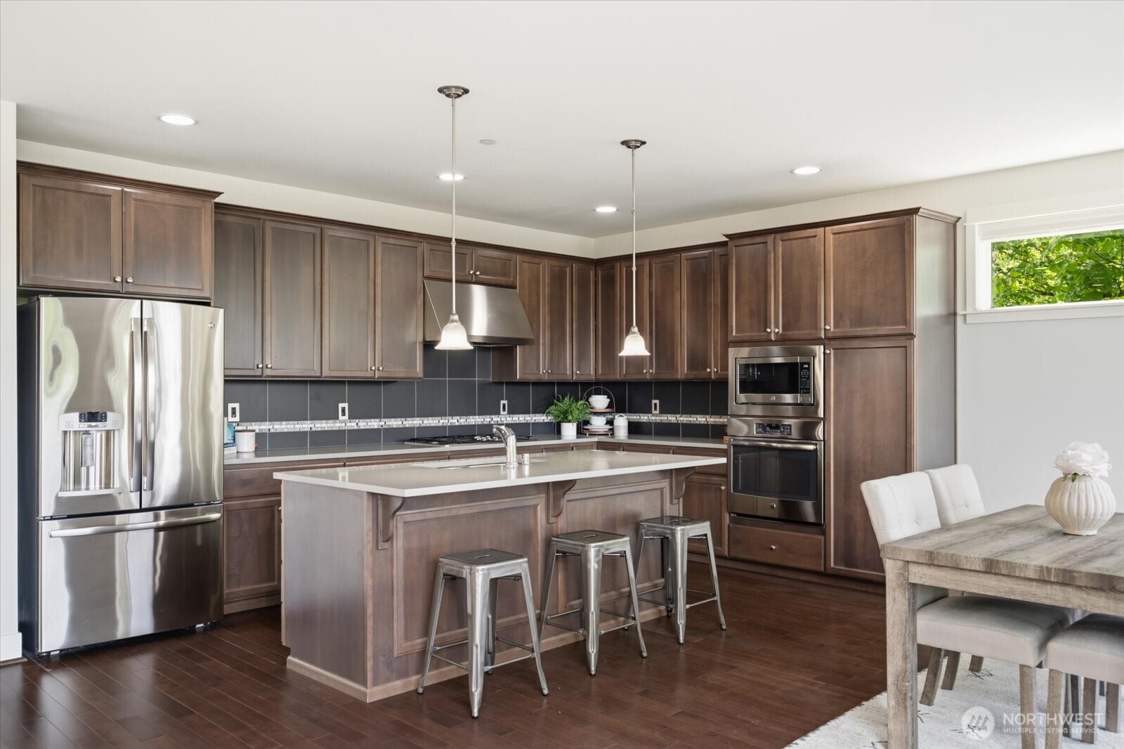 12102 Northeast 174th Street, Unit 1 Bothell, WA 98011 - Photo 8 of 40 a kitchen with kitchen island granite countertop a center island stainless steel appliances cabinets and a center island