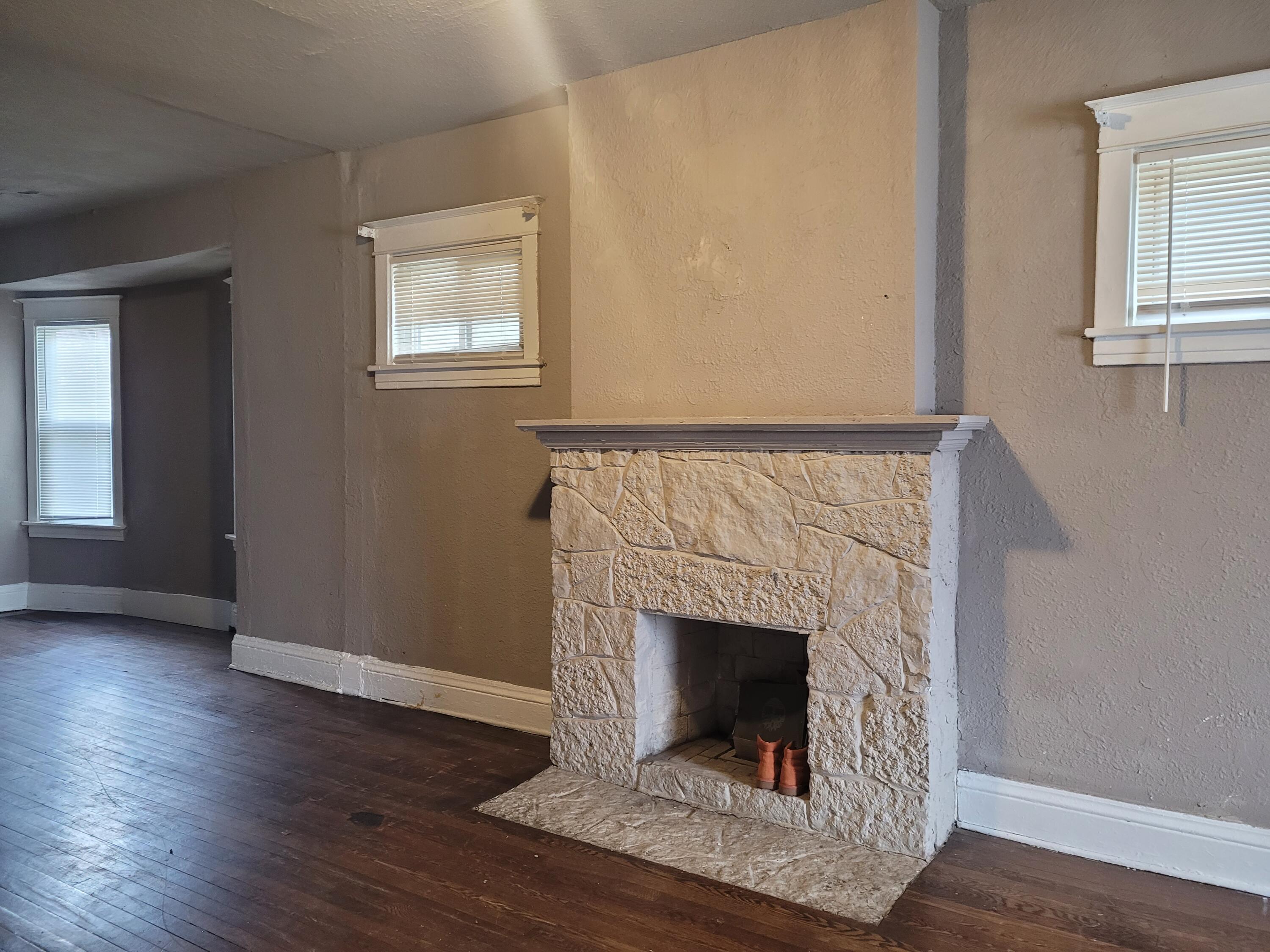 824 Tyler Street Gary, IN 46402 - Photo 2 of 14 a living room with a fireplace and wooden floor