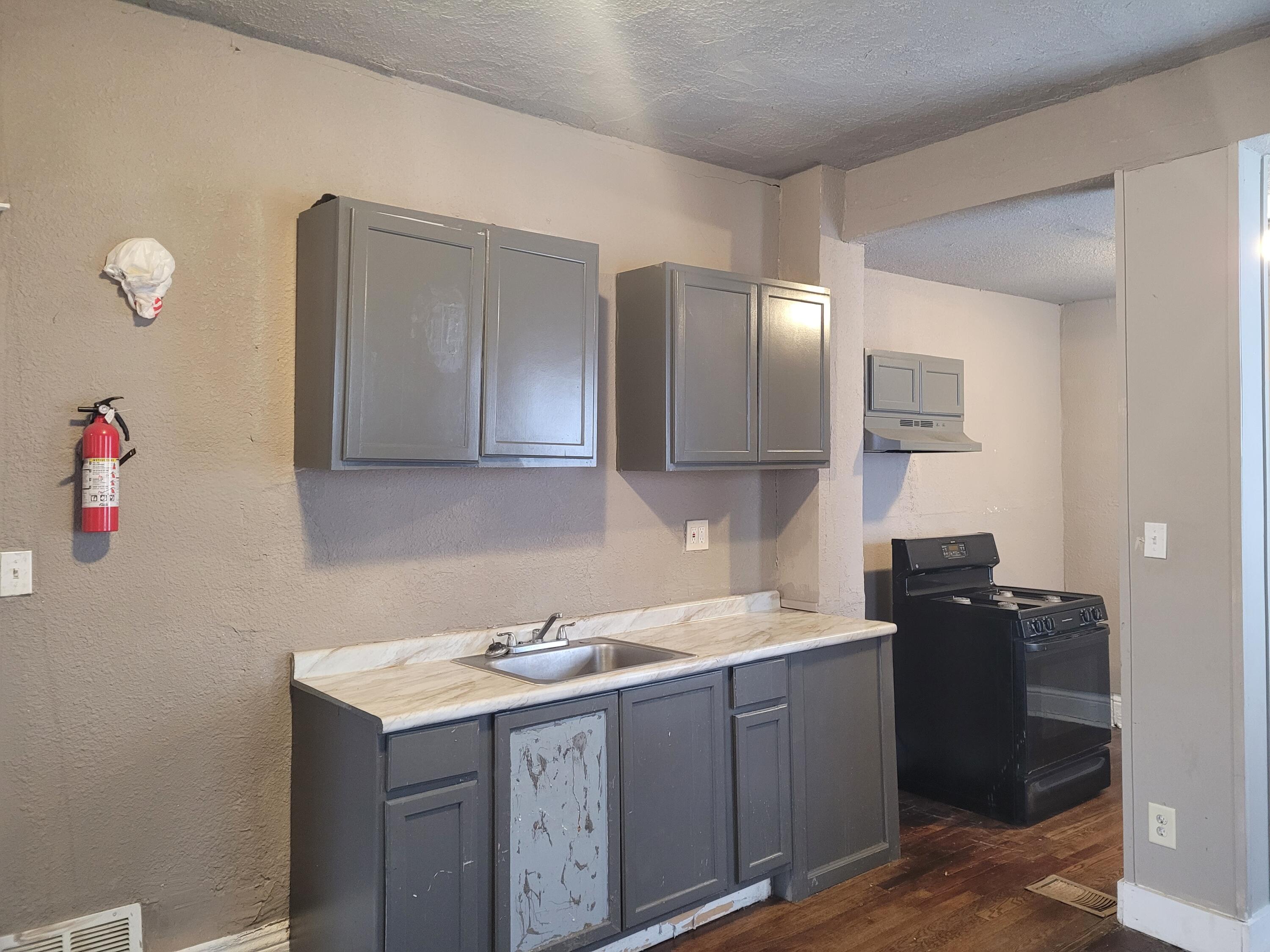 824 Tyler Street Gary, IN 46402 - Photo 3 of 14 a utility room with cabinets washer and dryer