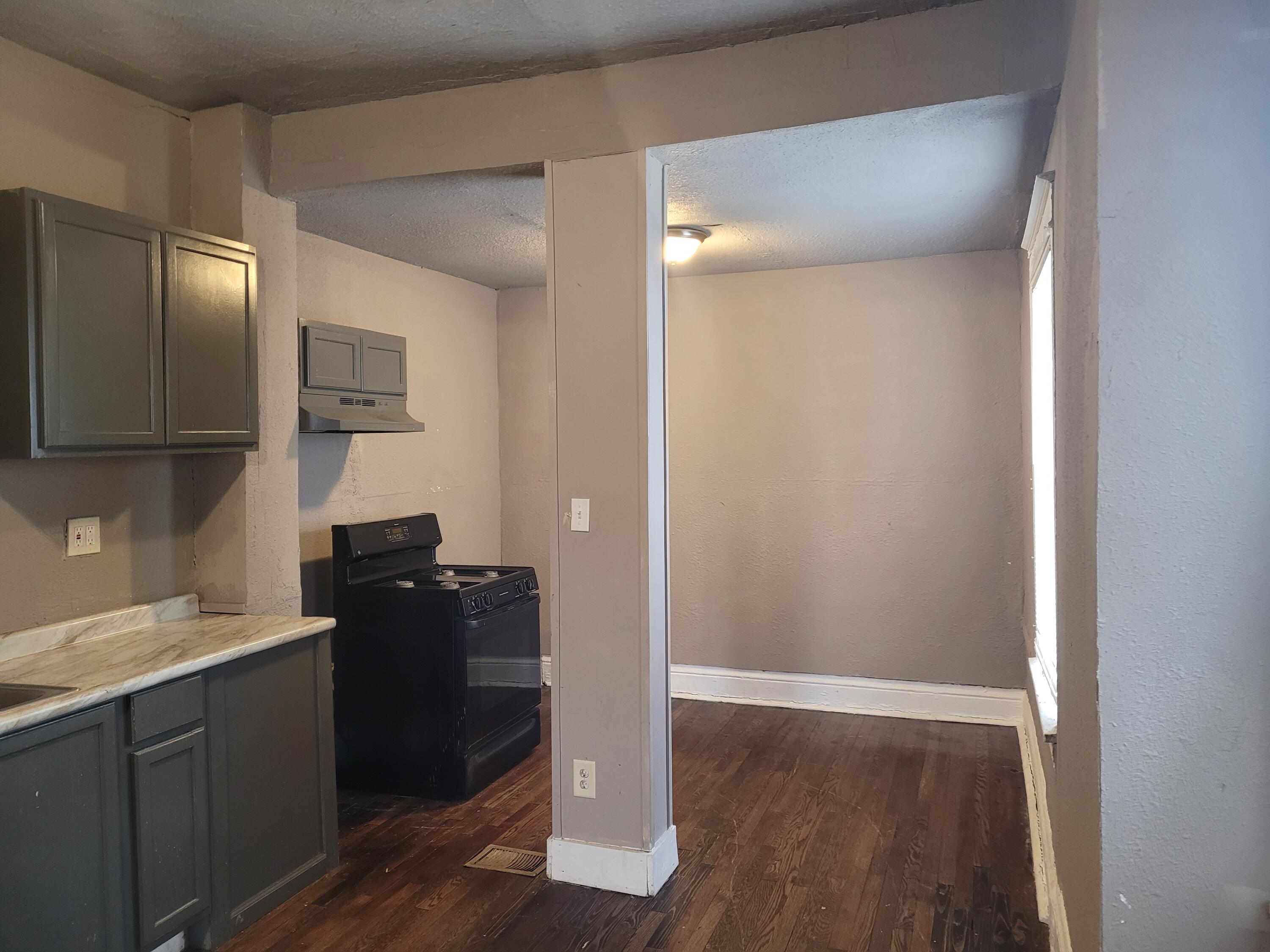 824 Tyler Street Gary, IN 46402 - Photo 4 of 14 a kitchen with a refrigerator and a sink