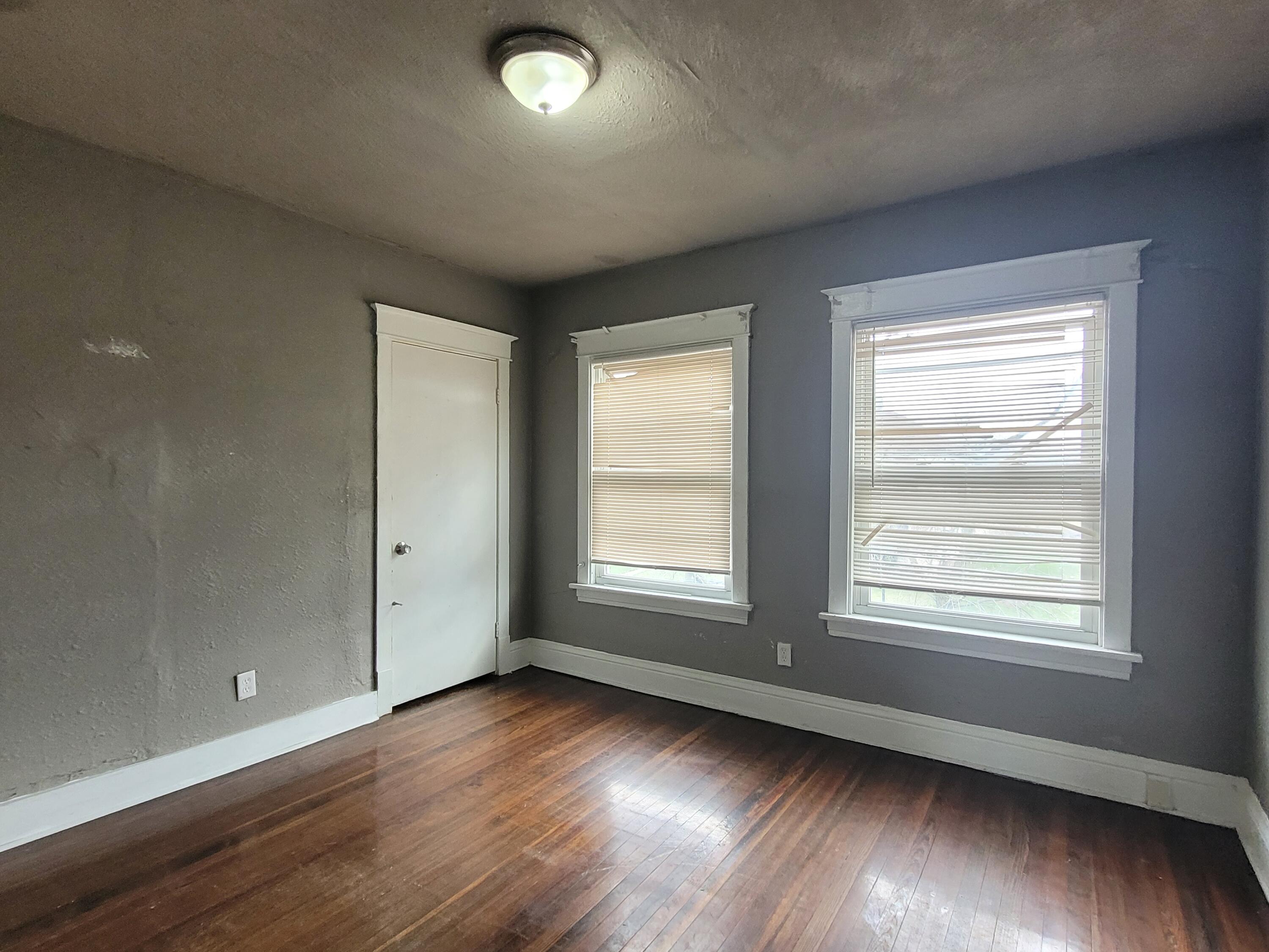 824 Tyler Street Gary, IN 46402 - Photo 6 of 14 an empty room with wooden floor and windows