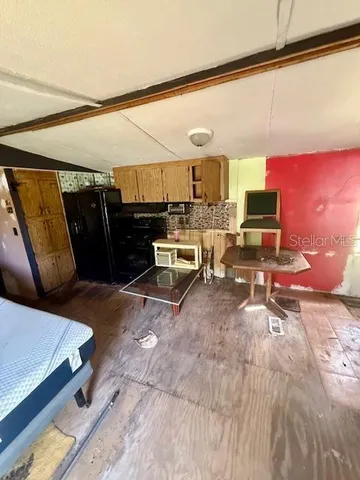 a view of living room with furniture and a rug