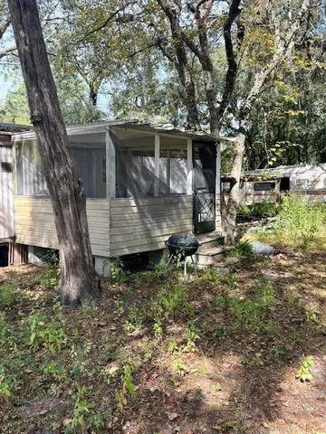 a view of a barn in the middle of a yard