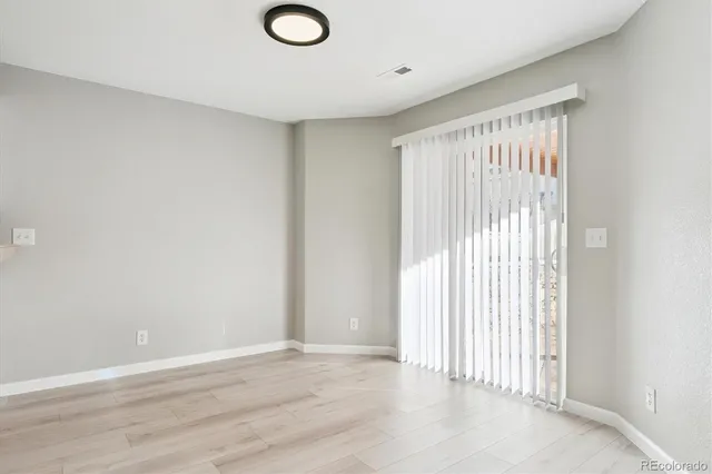 a view of a livingroom with wooden floor and window