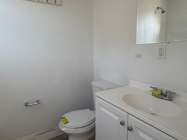 a white toilet sitting next to a bathroom sink