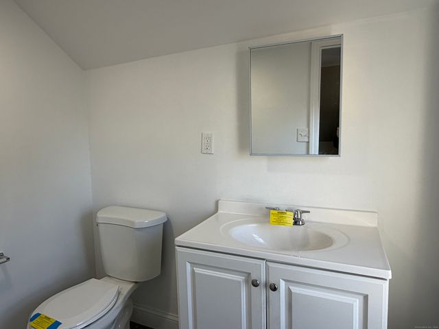 a bathroom with a sink a toilet and vanity