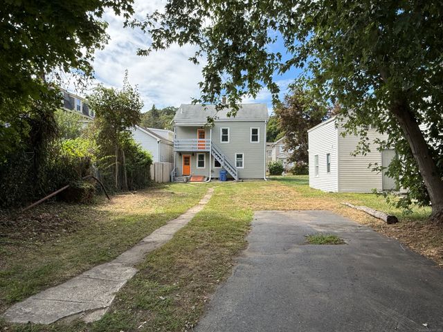 a view of a white house with a yard