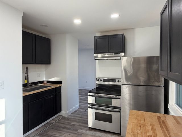 a kitchen with a stove and a refrigerator
