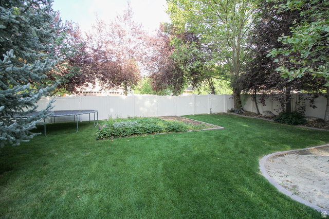288 525 South Providence, UT 84332 - Photo 52 of 71 Fenced backyard with a trampoline