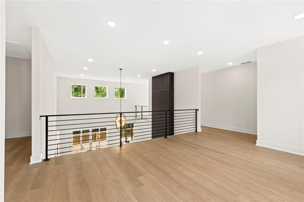 7066 Bells Way Fairburn, GA 30213 - Photo 49 of 64 a view of an empty room with wooden floor