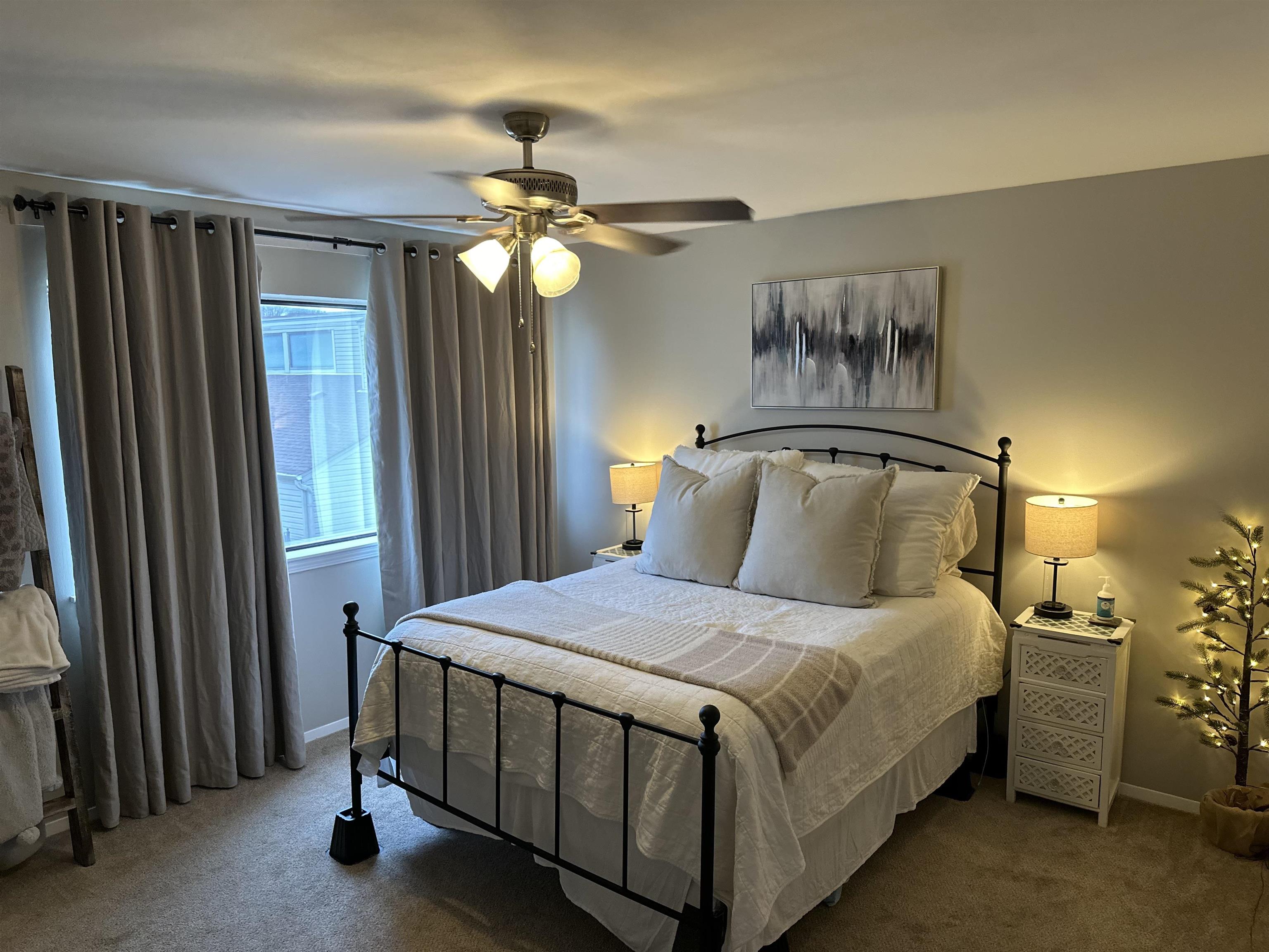 3081 Rising Sun Road, Unit 46 Lakeland, TN 38002 - Photo 16 of 30 a bedroom with a bed and a chandelier