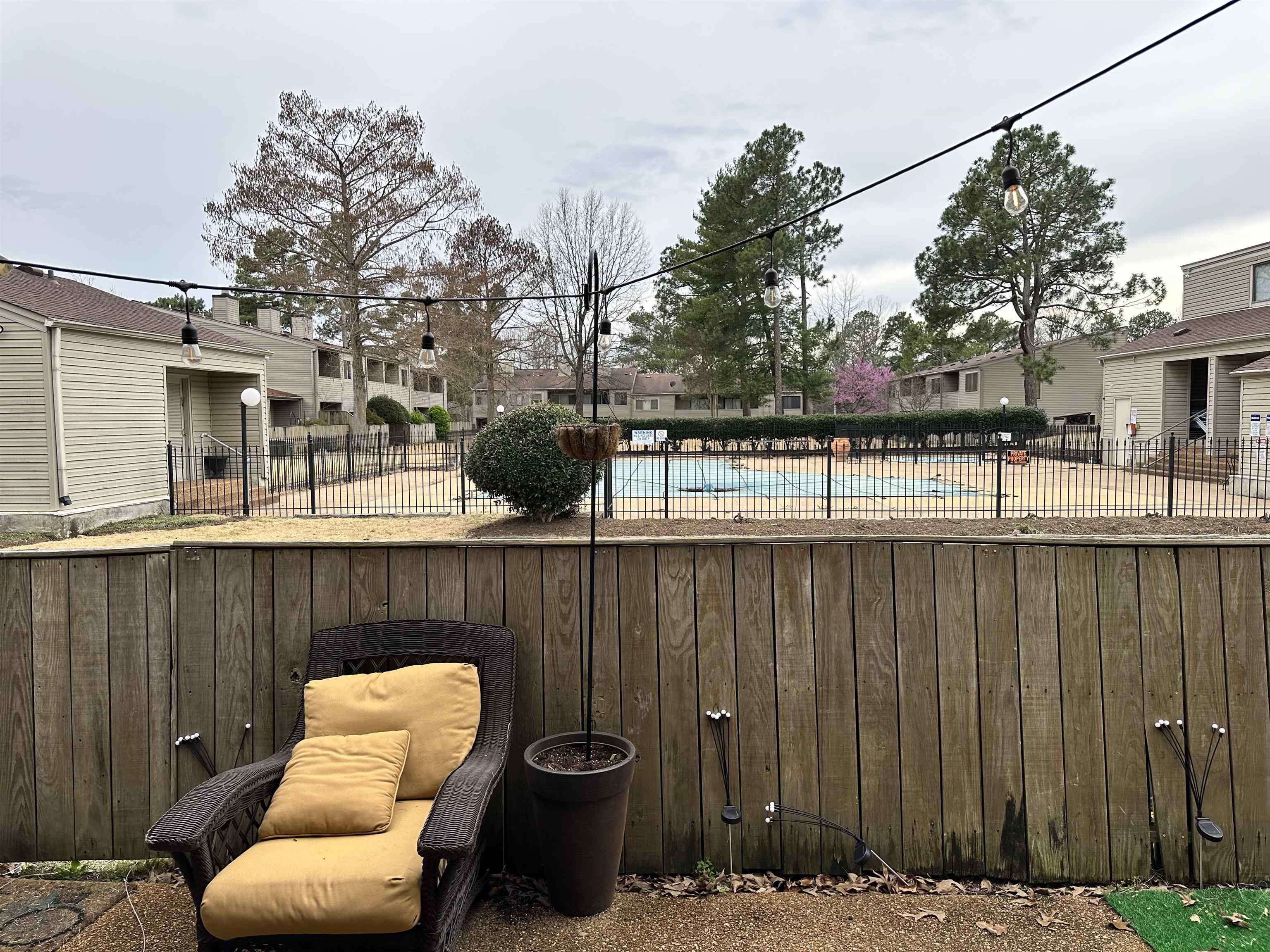 3081 Rising Sun Road, Unit 46 Lakeland, TN 38002 - Photo 30 of 30 a view of a patio with couches chairs and a fire pit with wooden fence