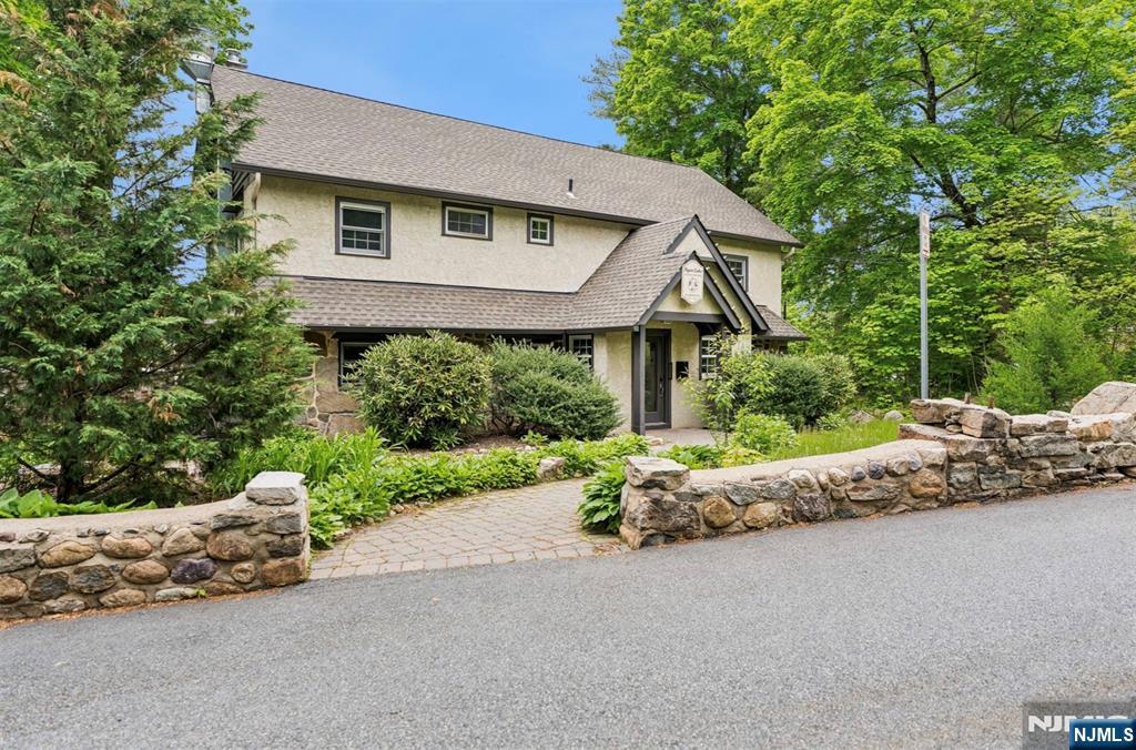 6 Waters Edge Butler, NJ 07405 - Photo 23 of 28 a front view of a house with a yard and shrubs