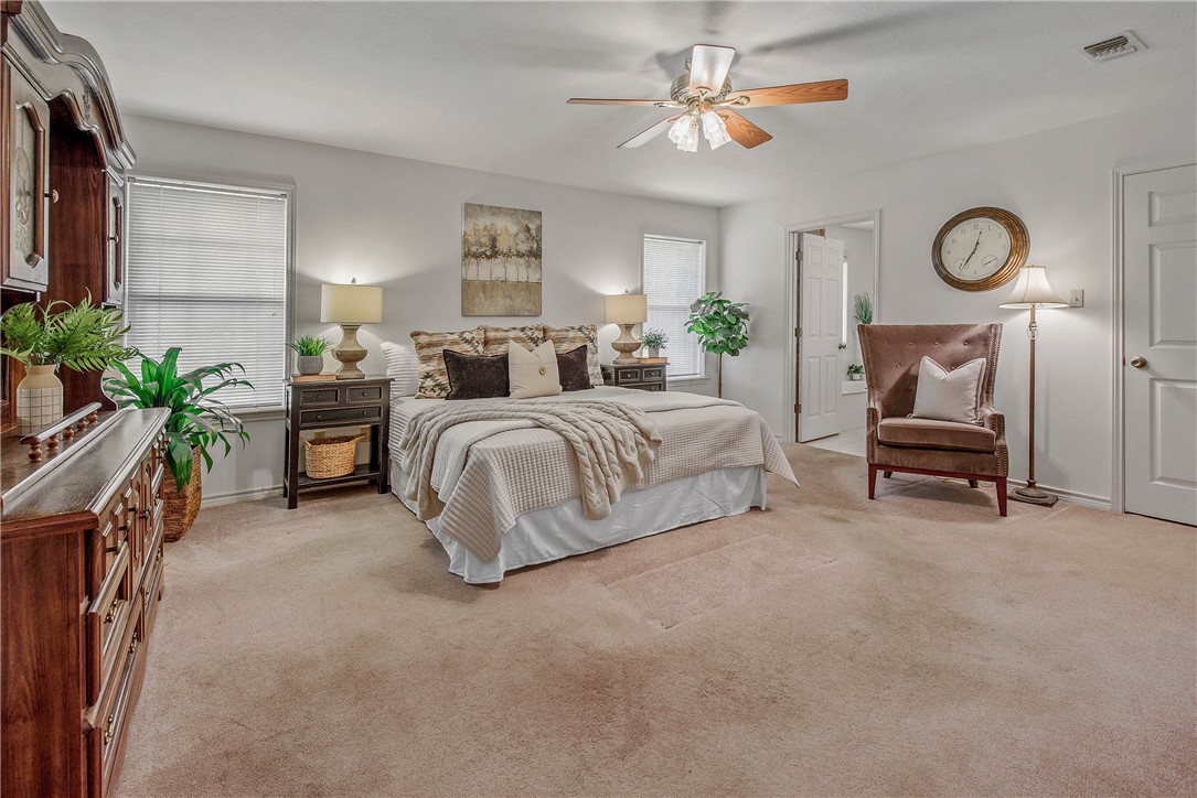 1110 County Road 439 Dime Box, TX 77853 - Photo 26 of 50 a spacious bedroom with a bed a couch and a chandelier